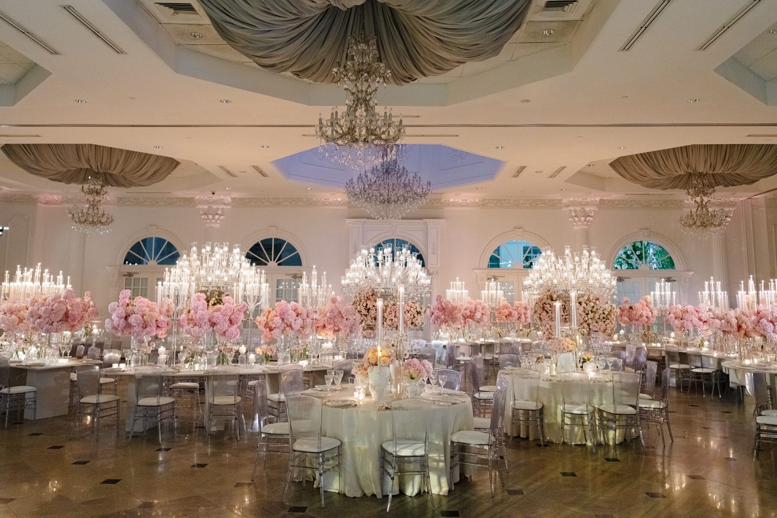 The ballroom at The Addison Park with crystal candelabras and pink florals