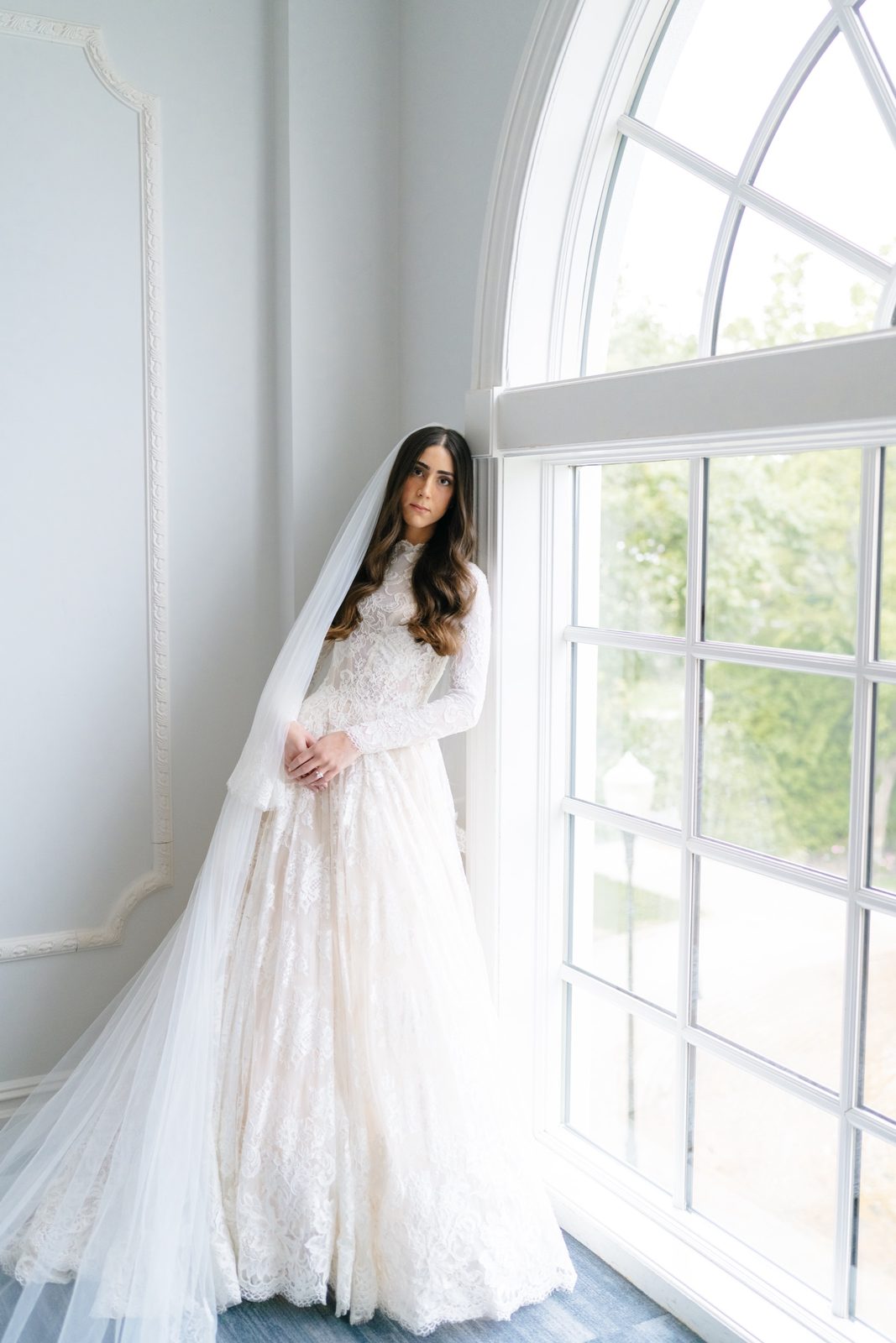 Adina in her veil at the arched window