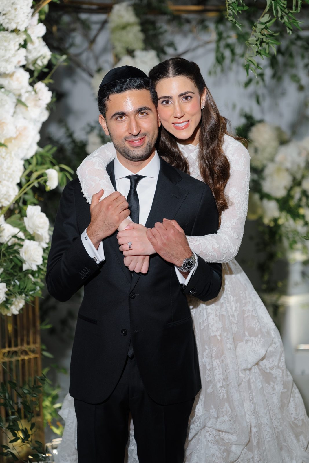 Adina wrapping her arms around David