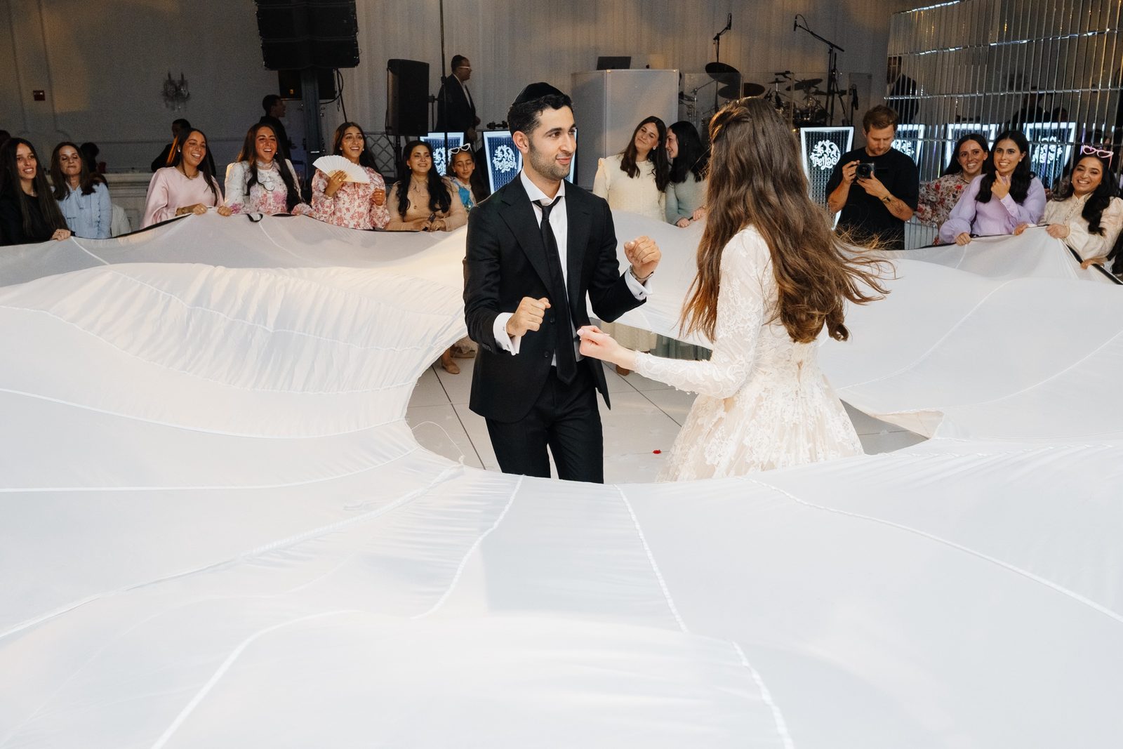 Adina and David dancing at the center of her train