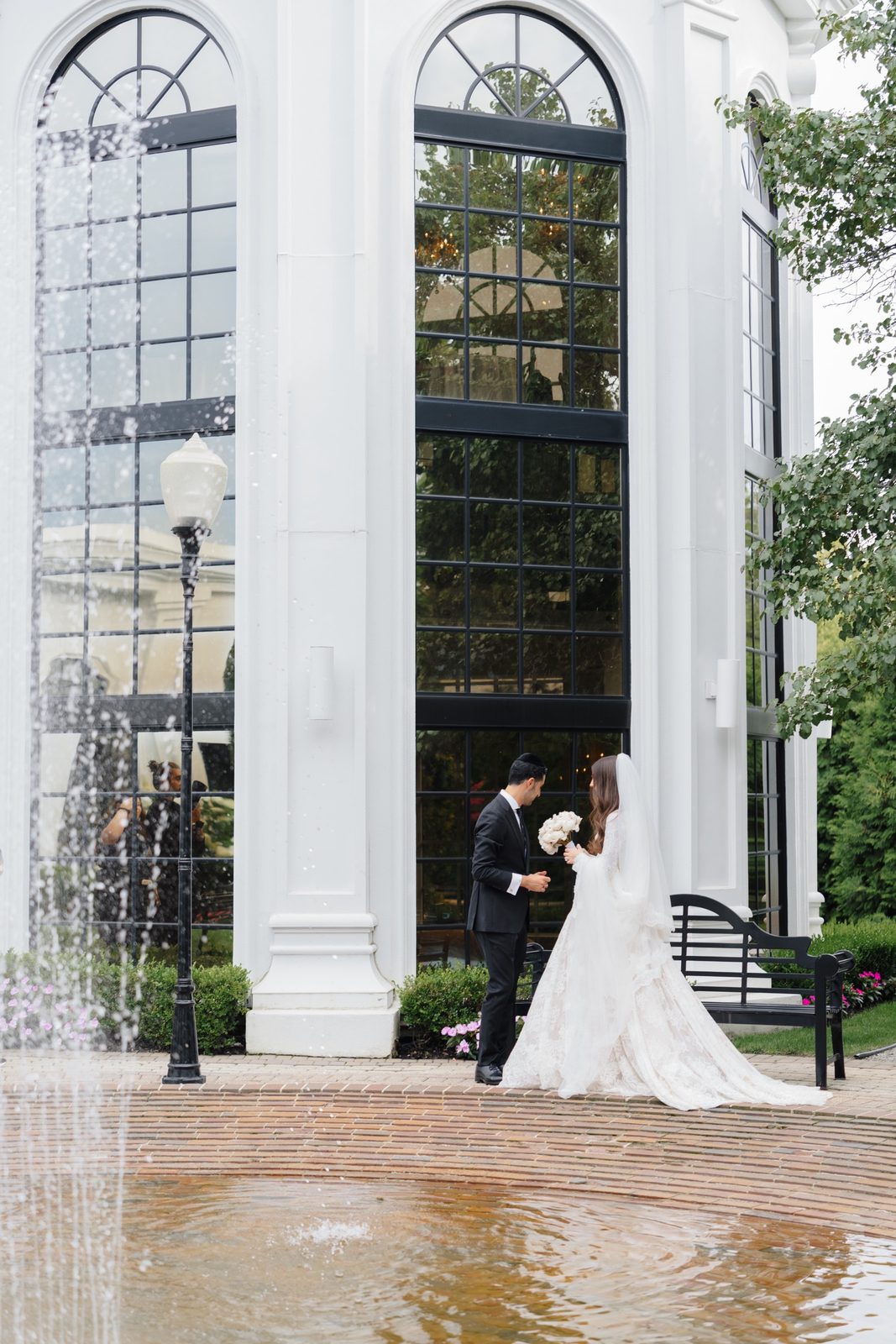 Adina and David by the glass pavilion and fountain at The Addison Park