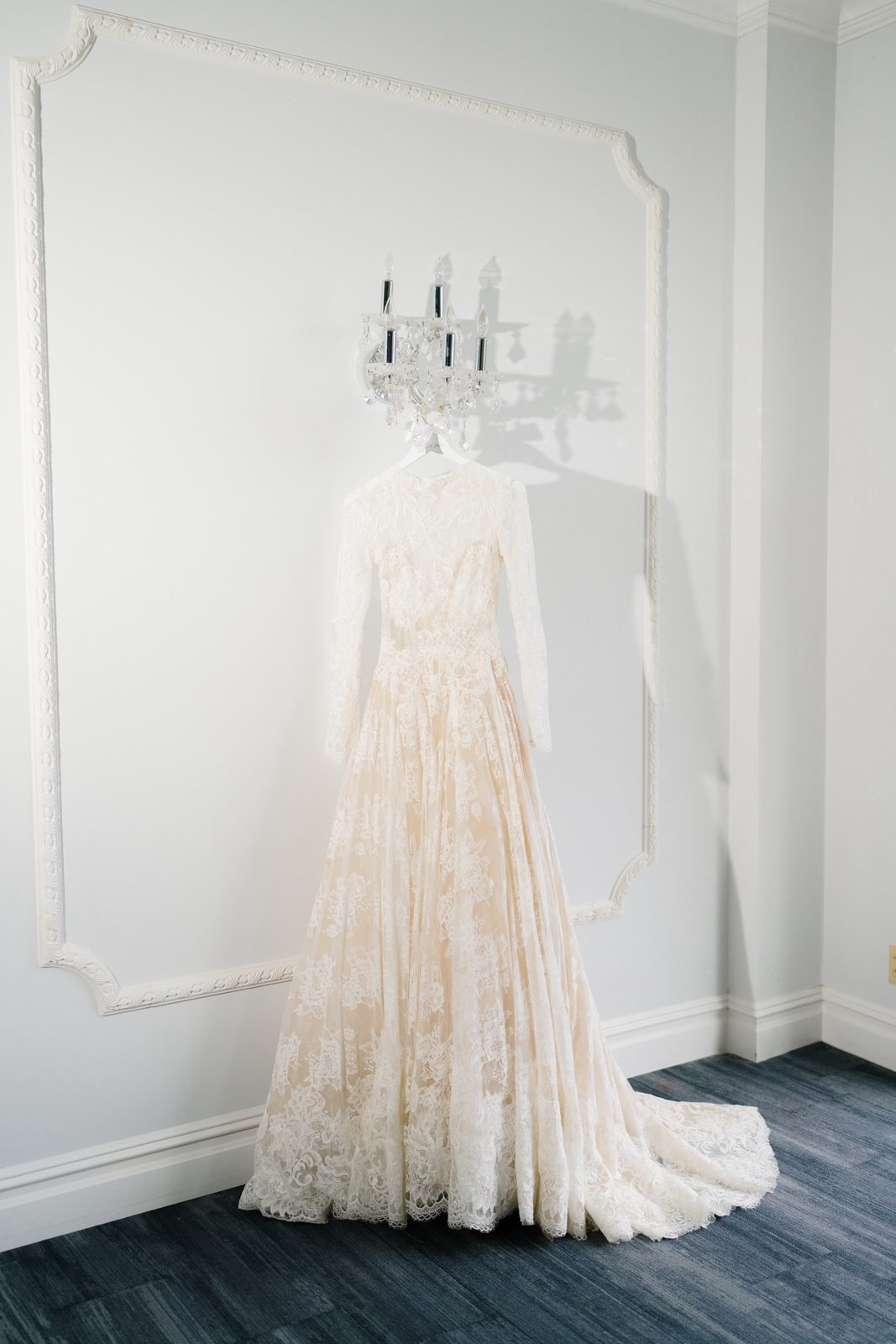 Adina’s lace gown hanging in the bridal suite at The Addison Park