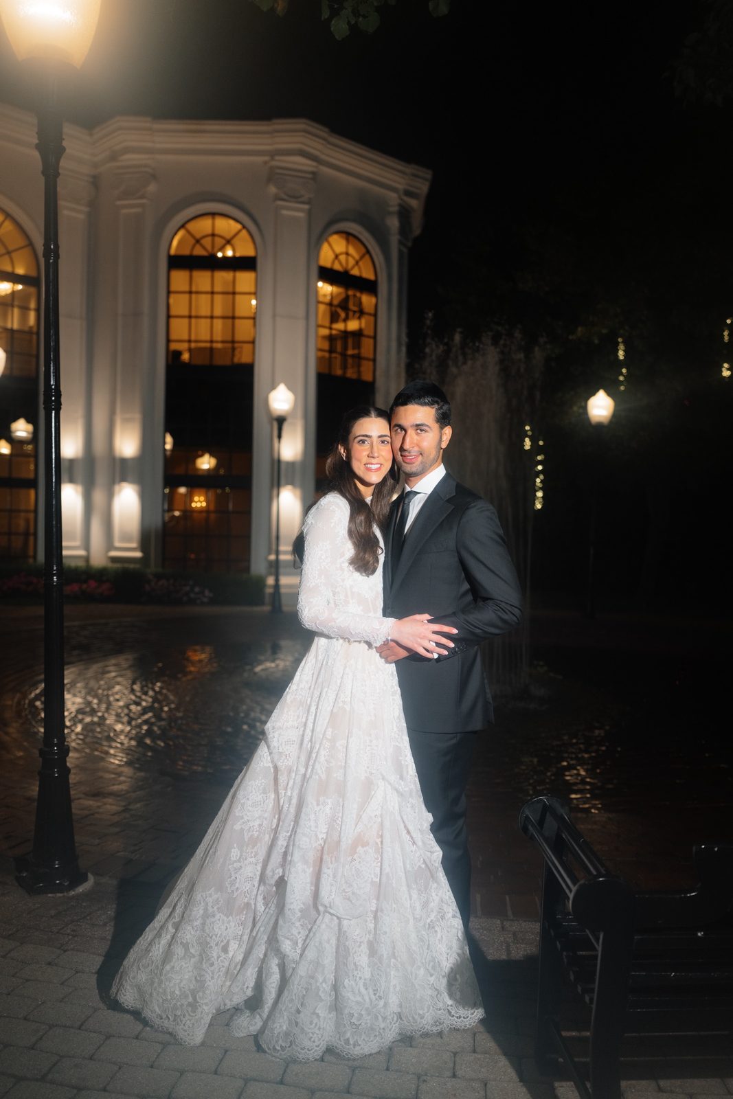 Night portrait of Adina and David by the lit pavilion