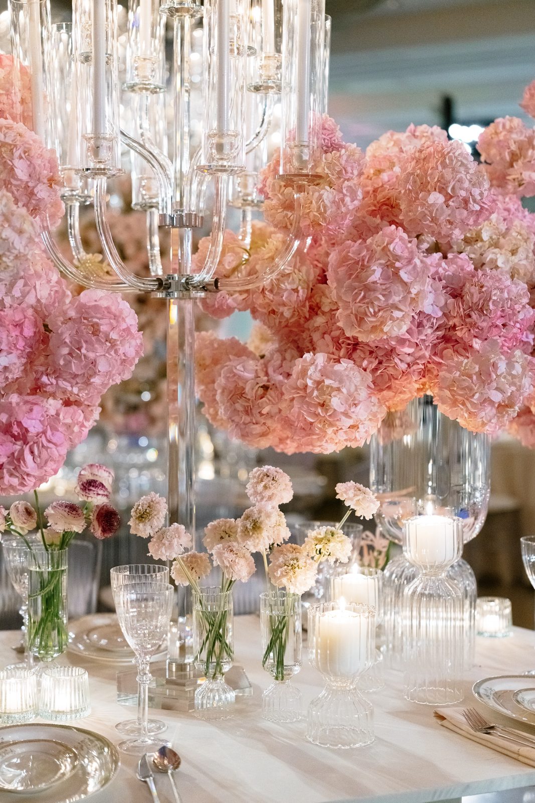 A pink hydrangea centerpiece under crystal