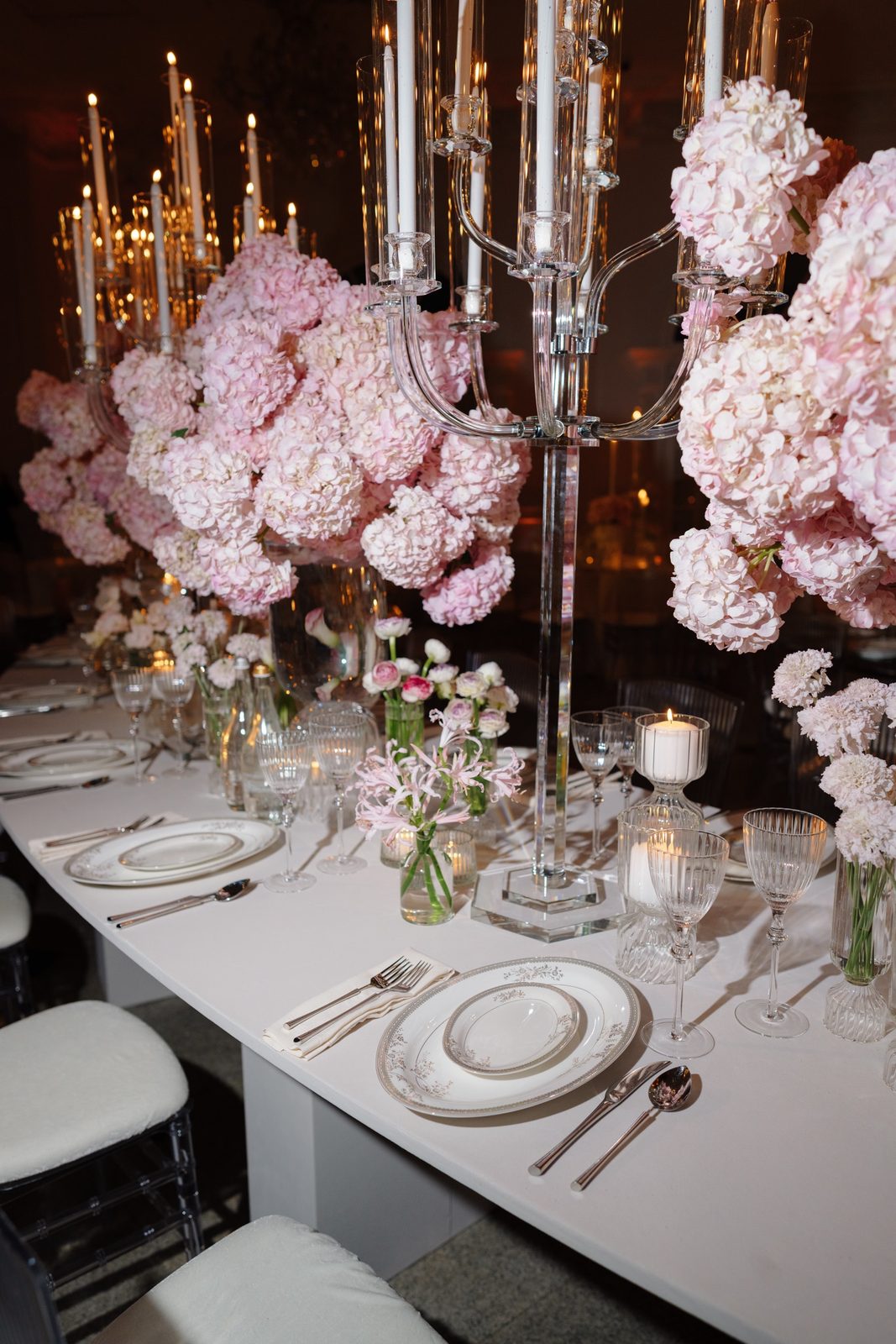 A table set with candles and pink flowers