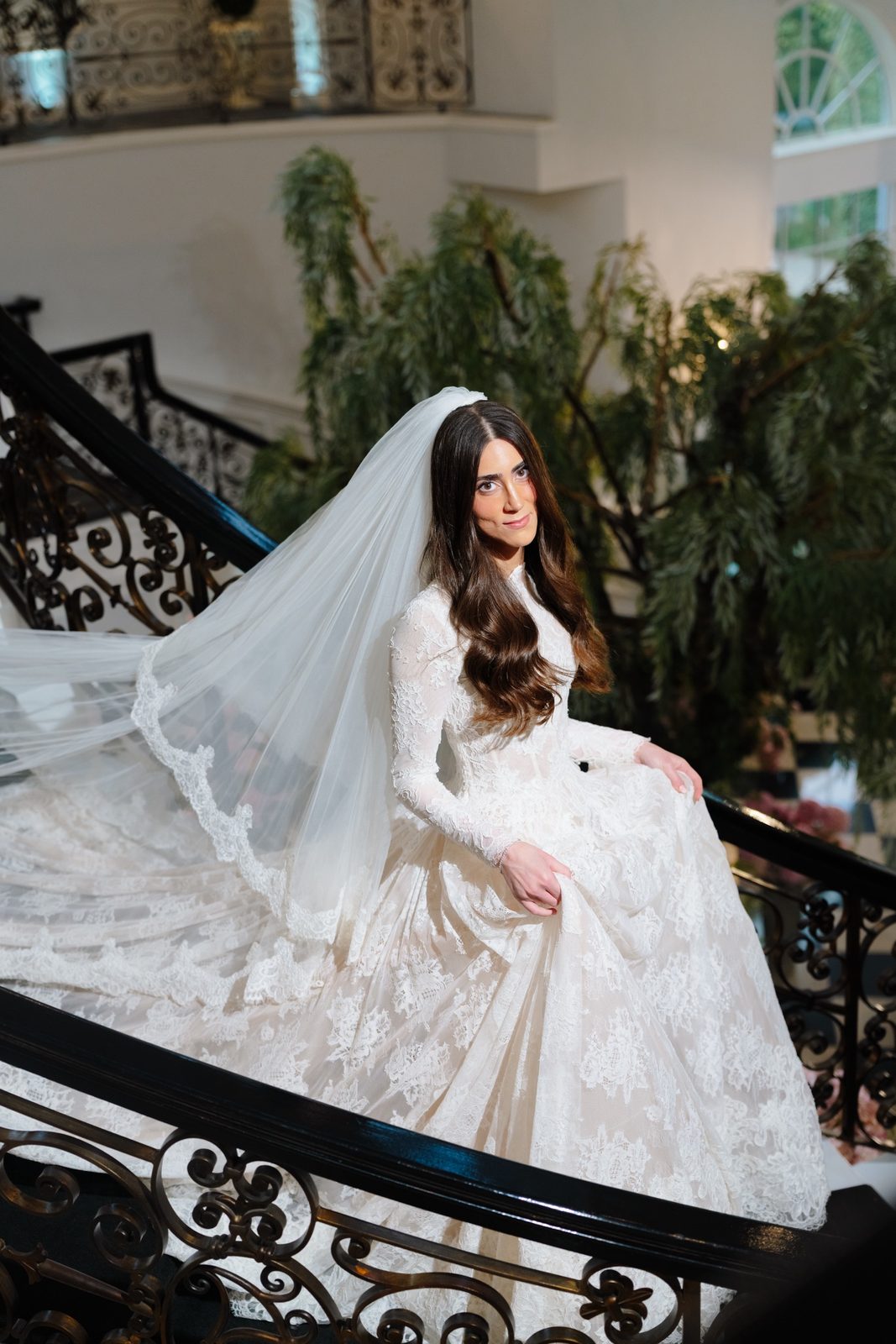 Adina’s veil spread across the staircase