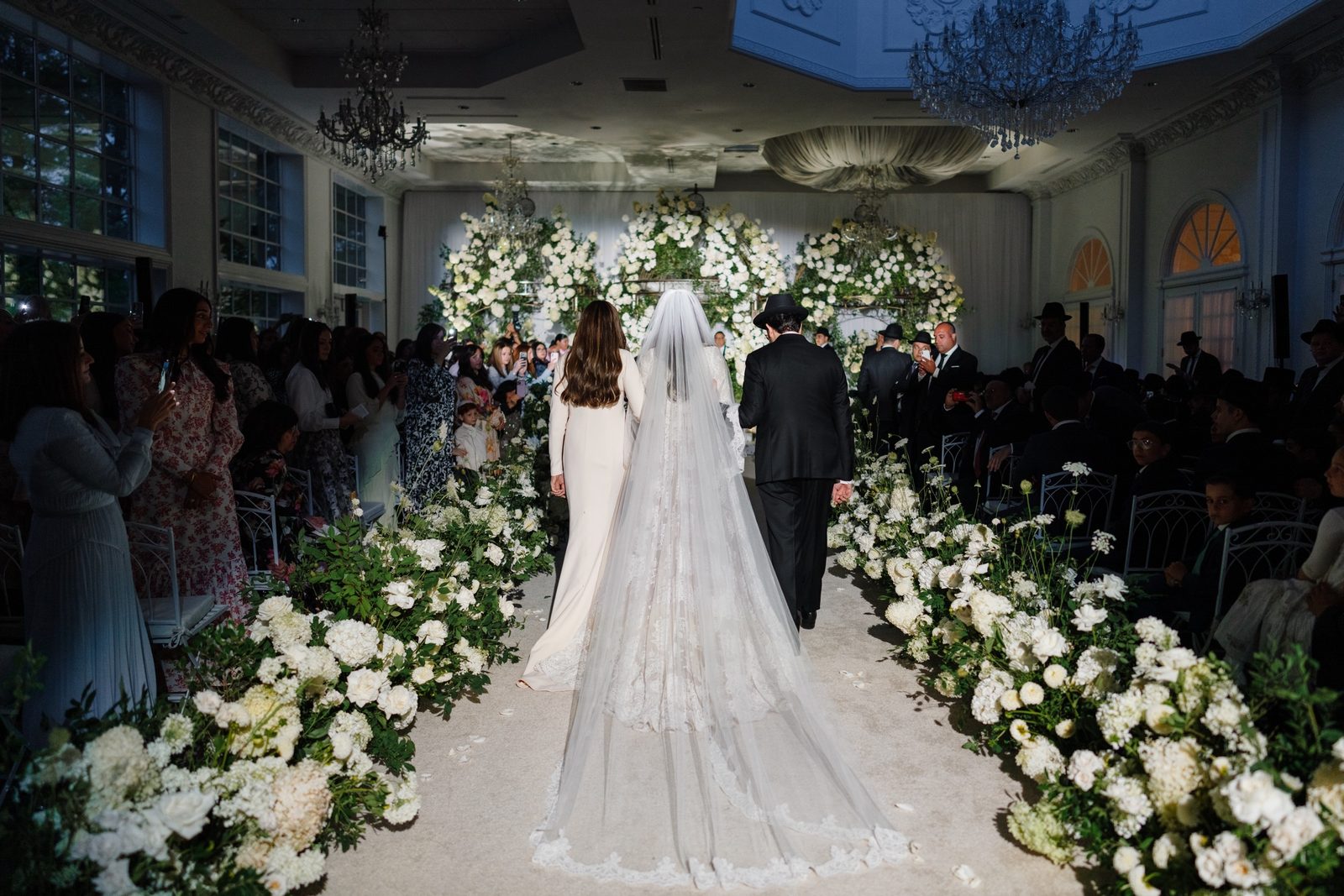 Adina walking down the white rose aisle