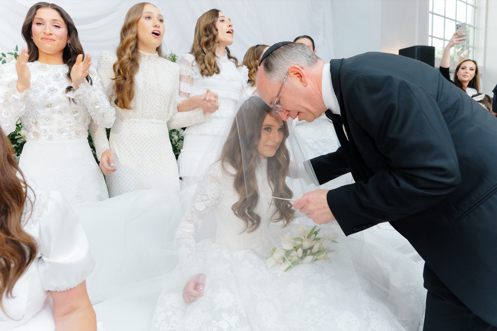 Ezra lowering Atara’s veil at the bedeken