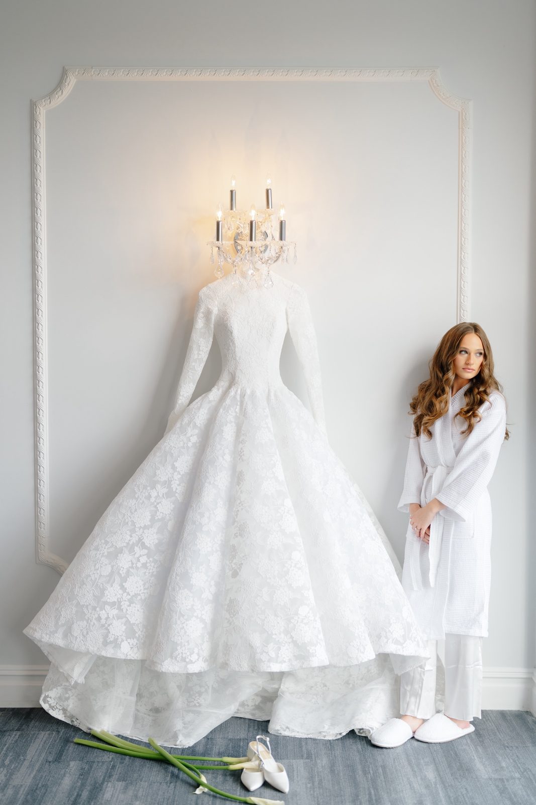 Atara in her robe beside her gown in the bridal suite