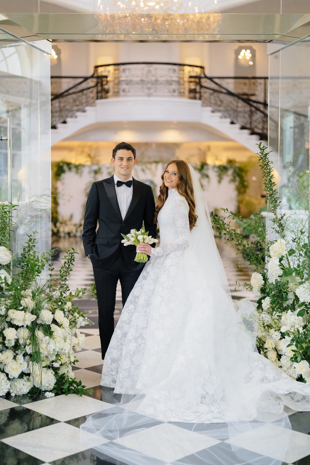 Atara and Ezra at the foot of the grand staircase