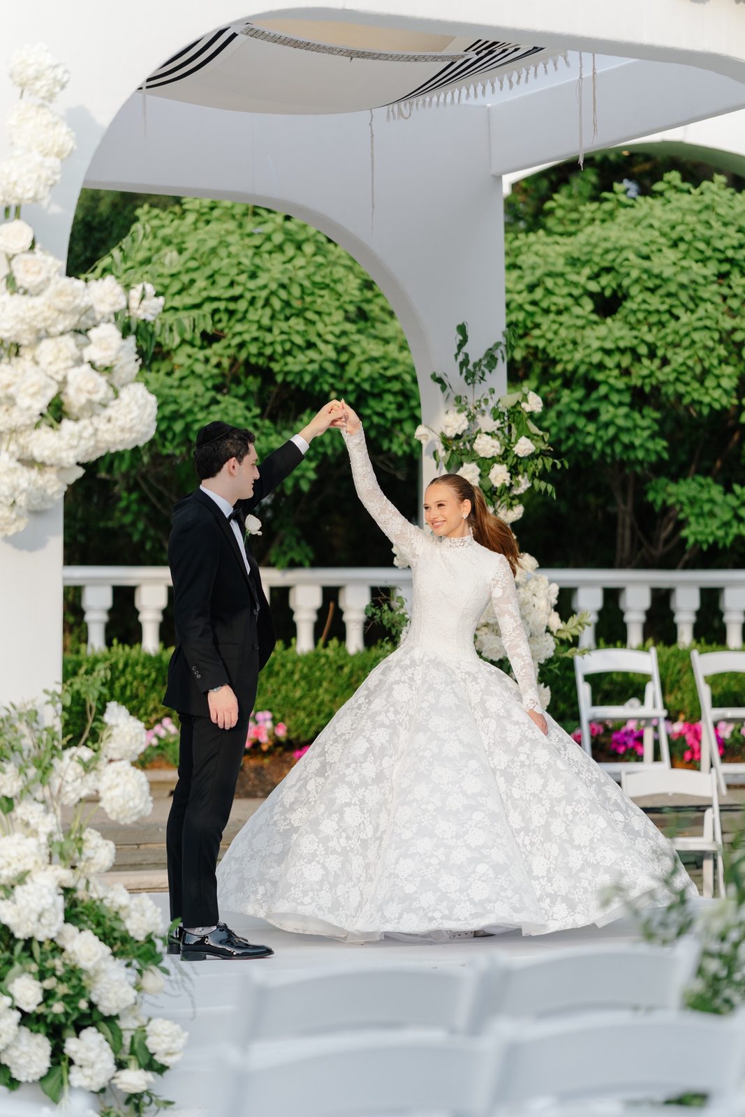 Ezra spinning Atara under the pergola after the ceremony