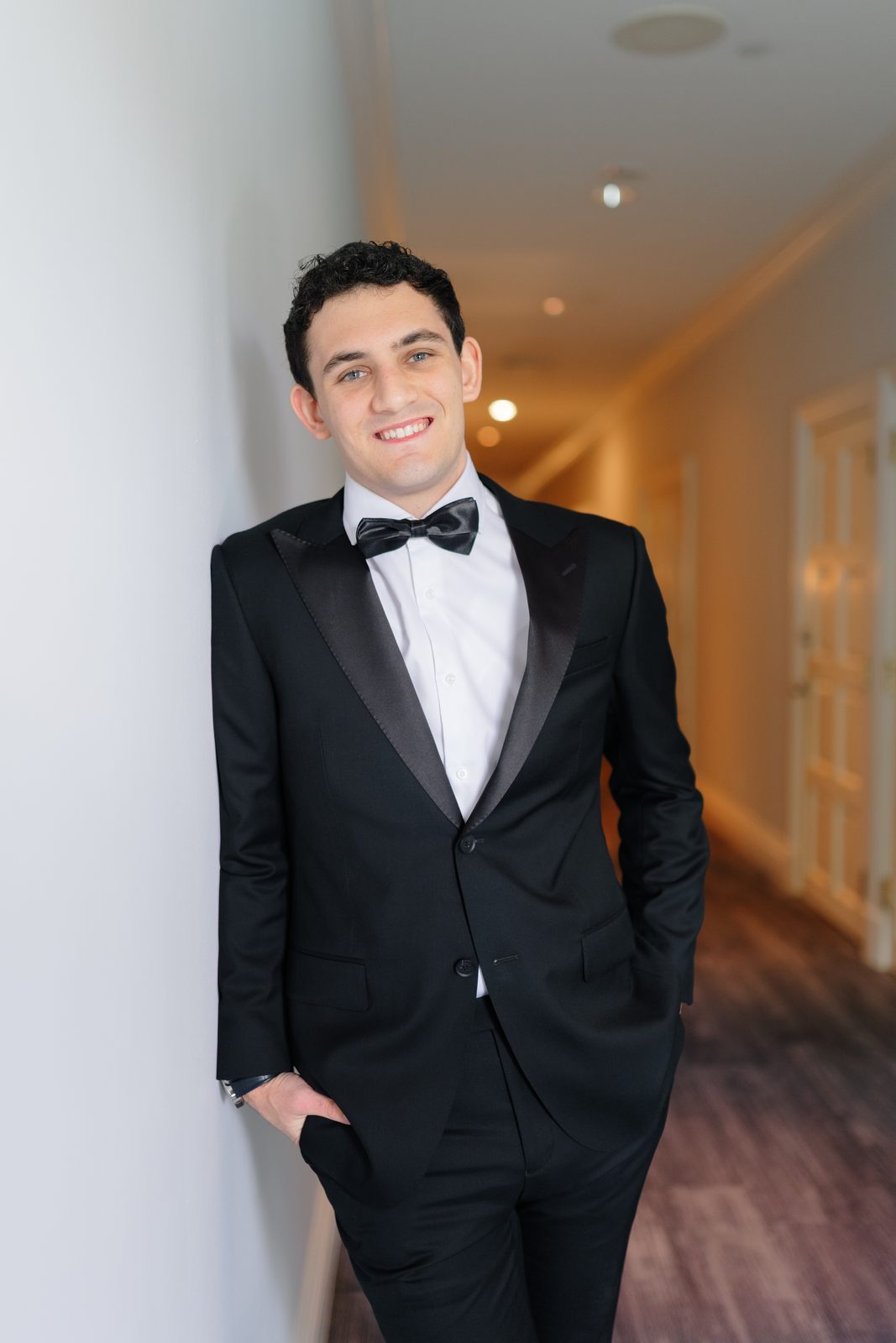 Ezra smiling in the hallway before the ceremony