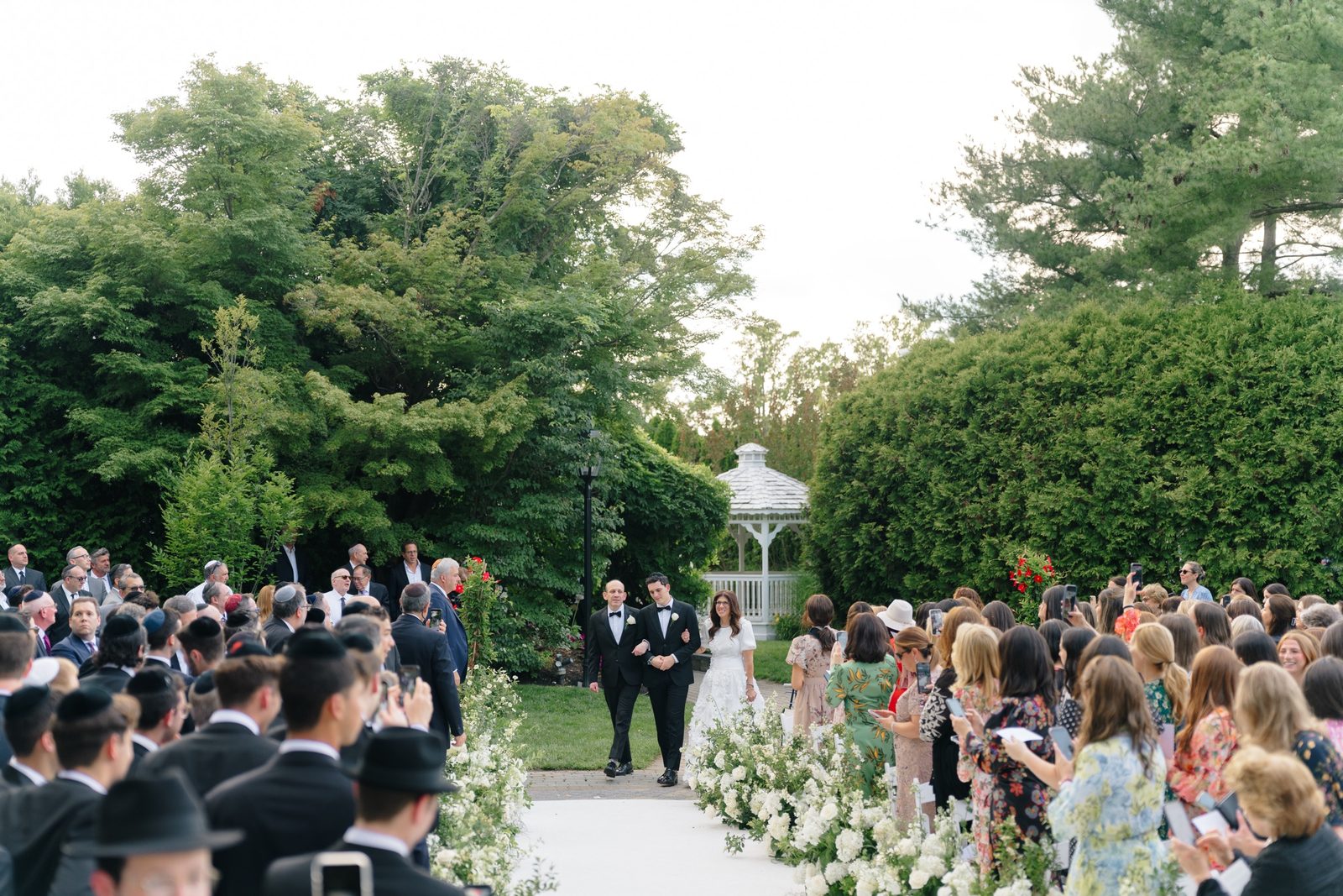 Guests seated in the garden for the outdoor ceremony