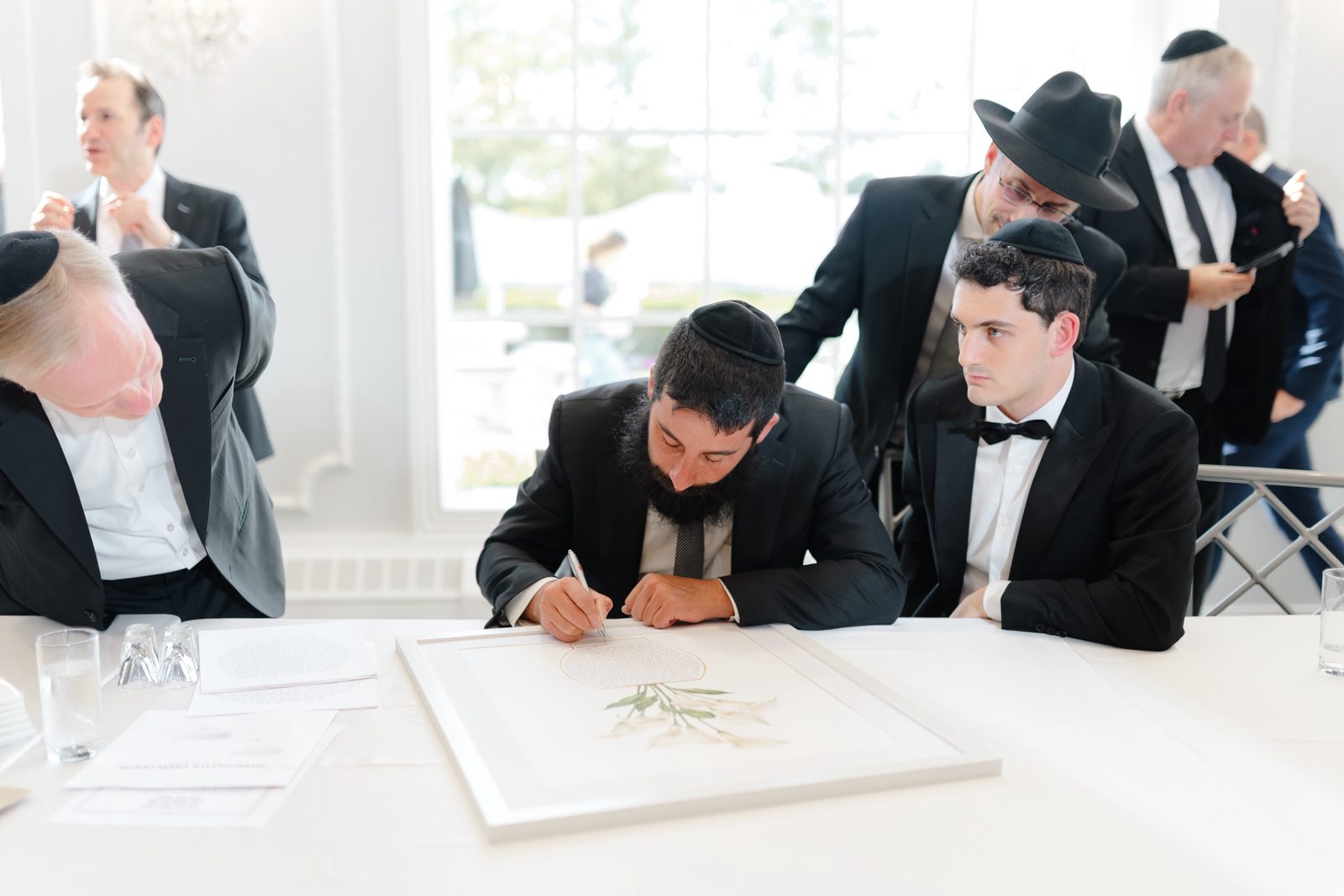 Ezra signing the ketubah