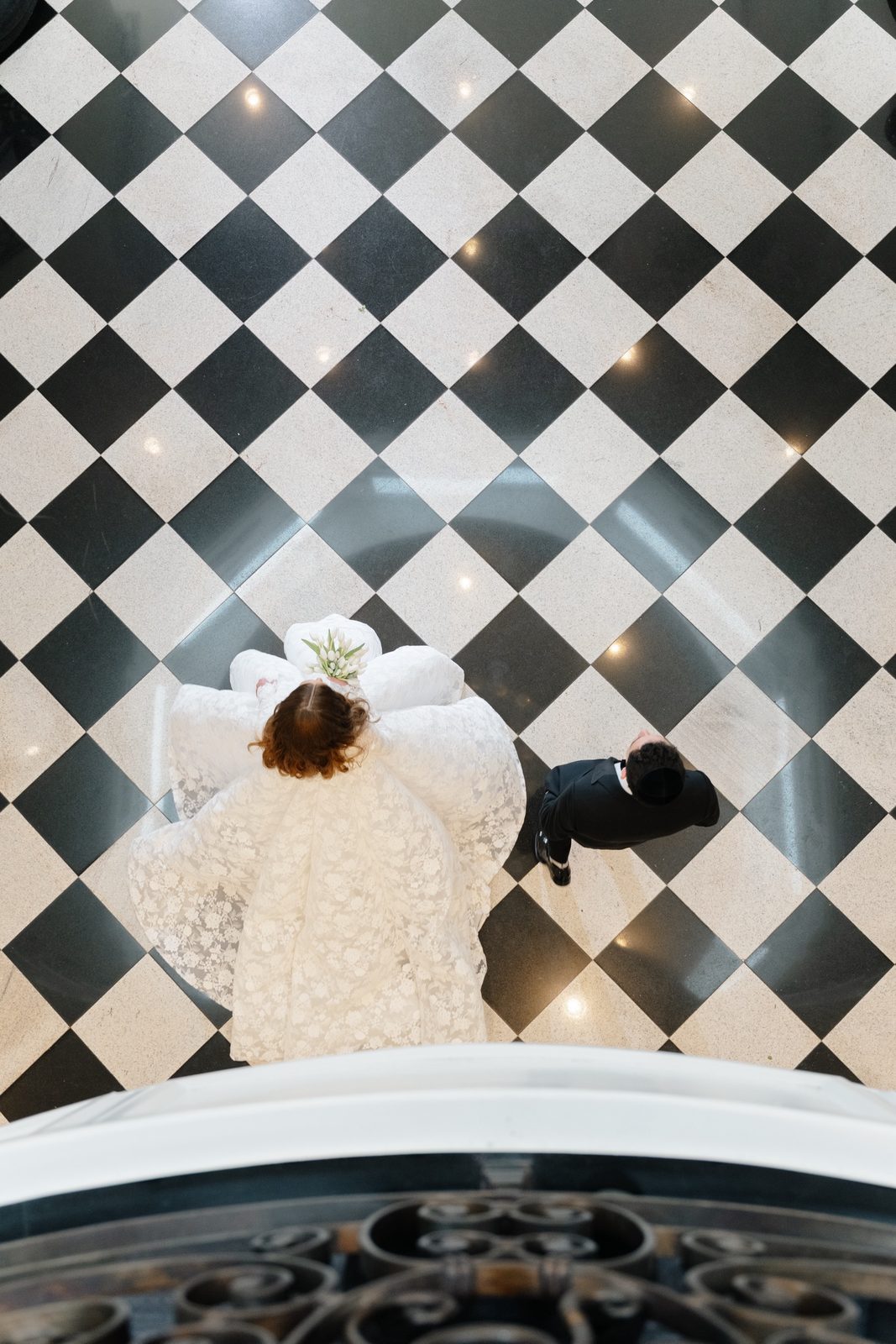 Looking down from the staircase at Atara’s gown on the checkerboard floor