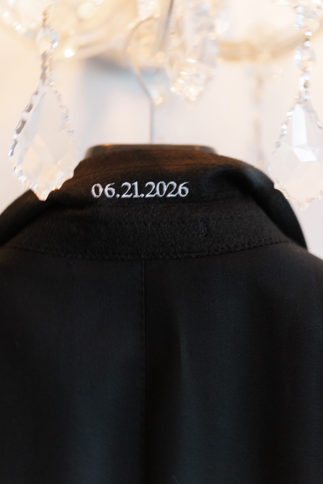 The wedding date stitched inside Ezra’s jacket, 06.21.2026