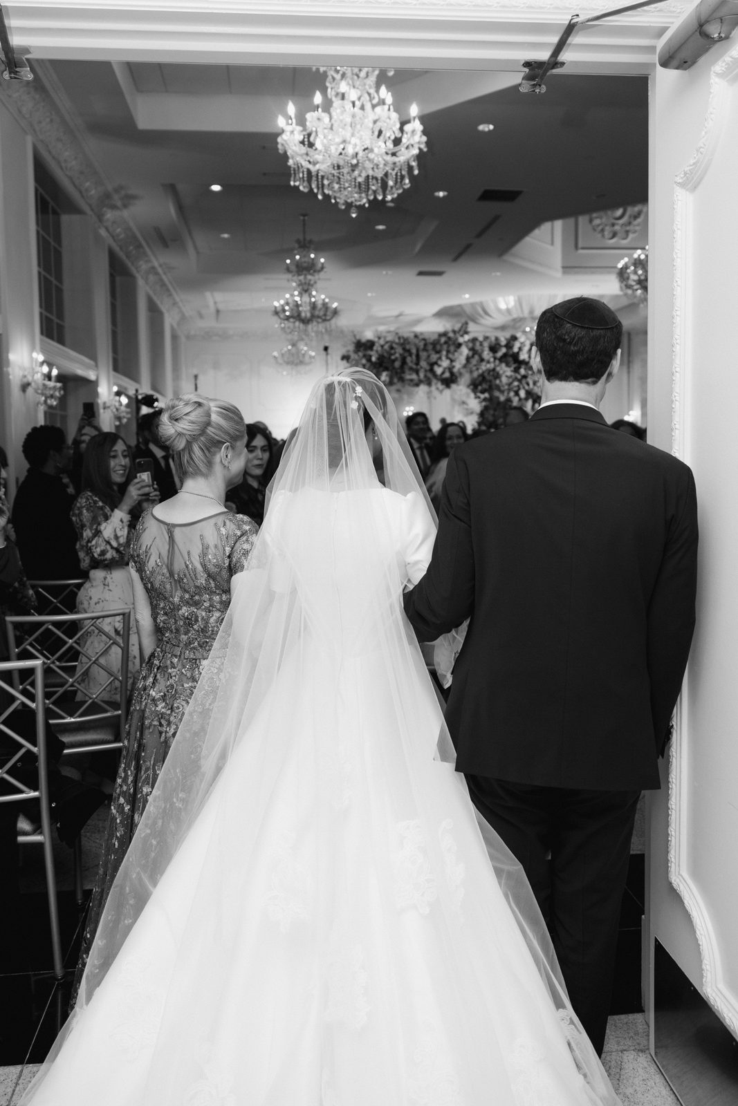 Black and white of Kayla and Gabriel leaving the ceremony