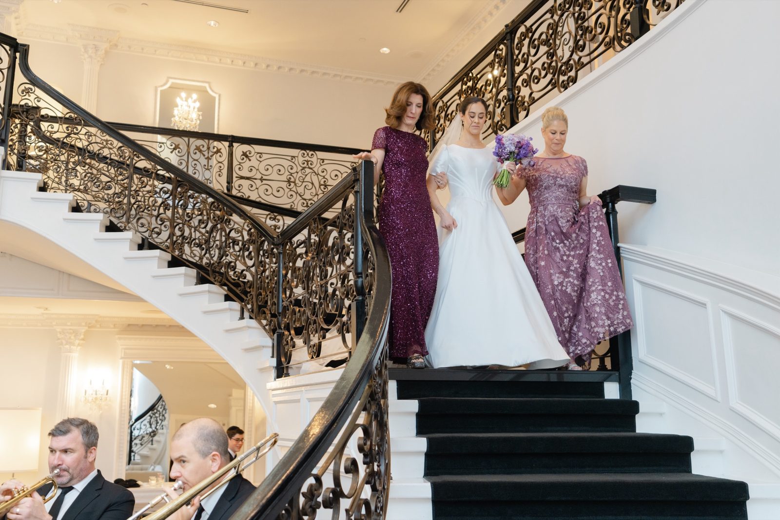 Kayla coming down the grand staircase with her mothers