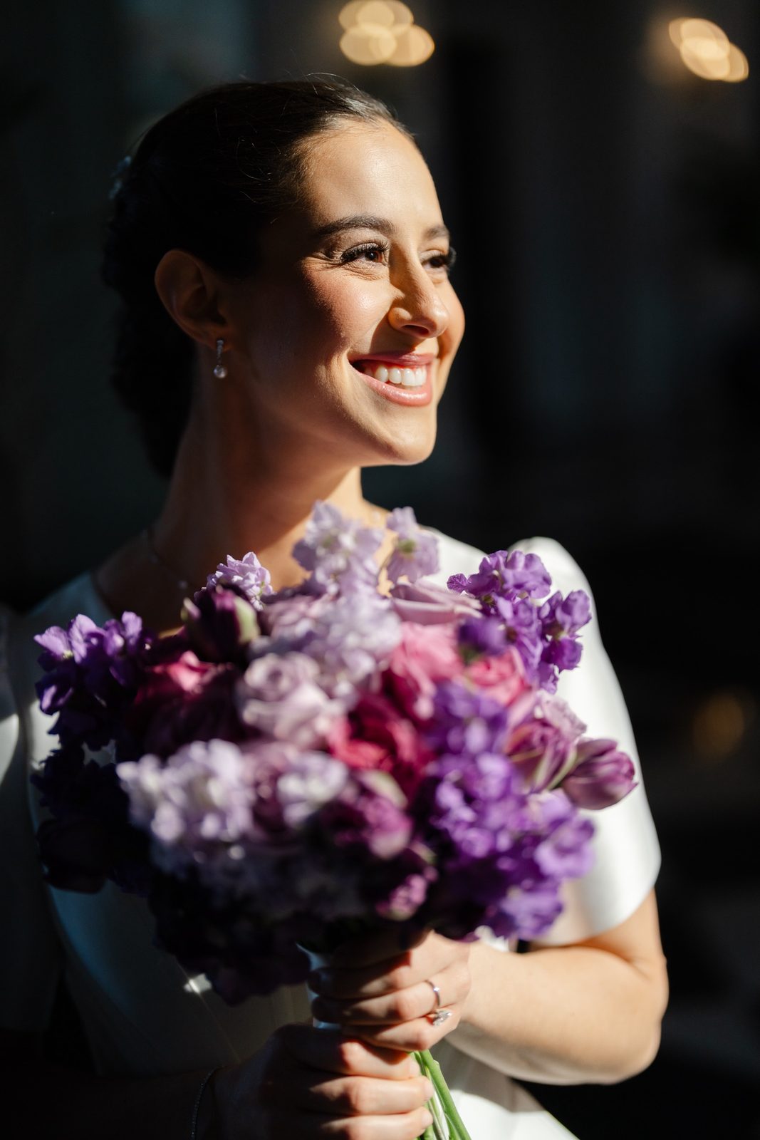 Kayla in late afternoon sun with her purple bouquet