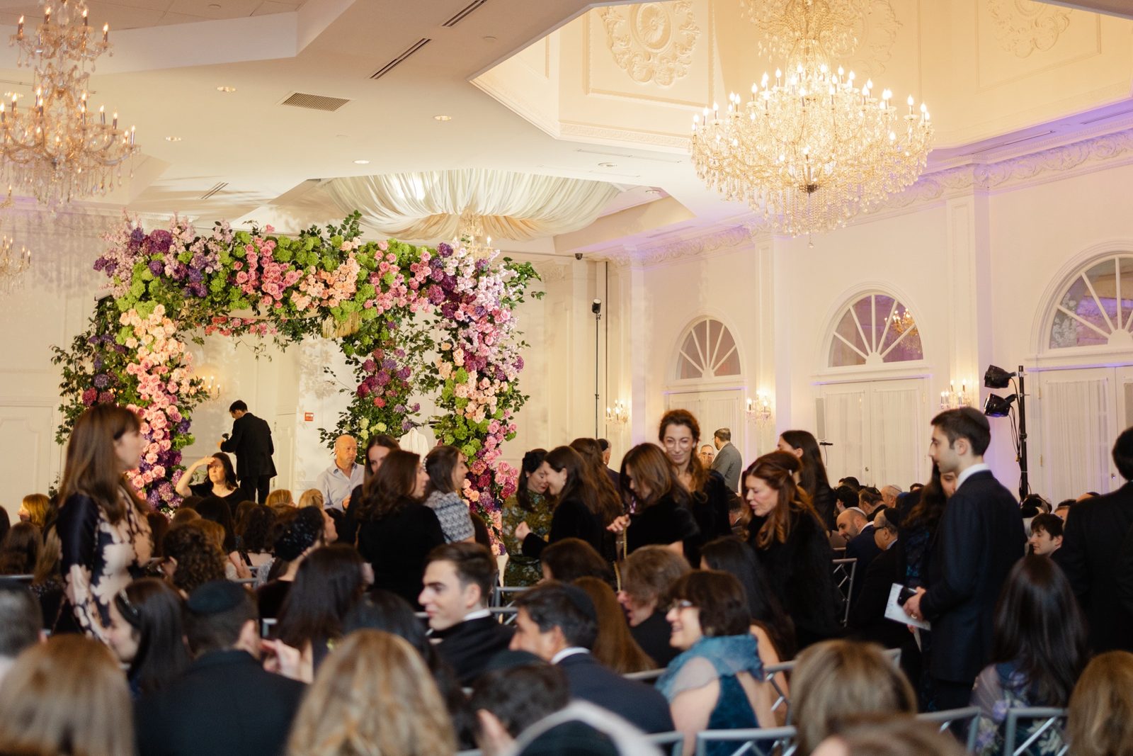 The ceremony under a floral chuppah in the ceremony room at The Addison Park