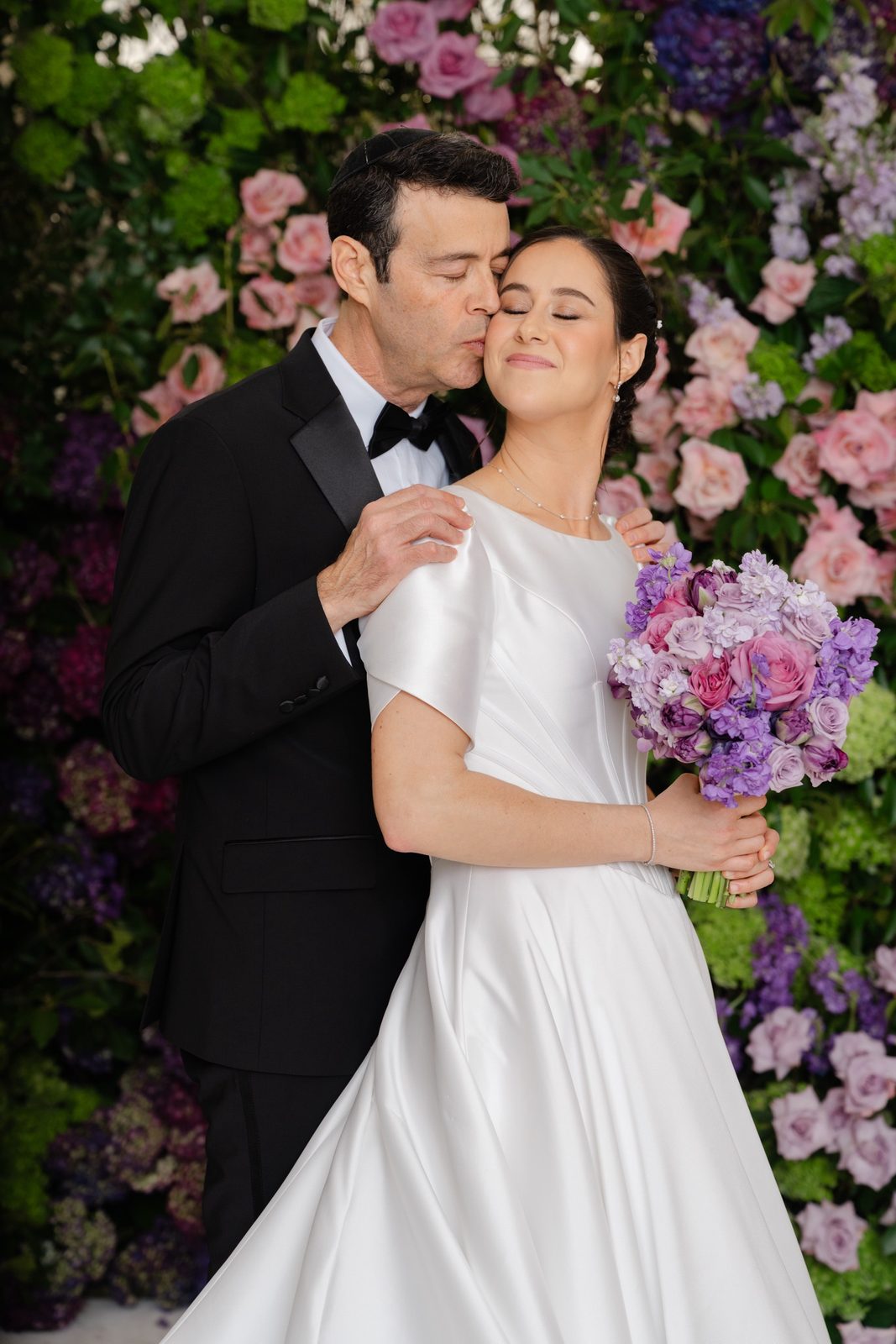 Kayla and Gabriel at the pink and purple flower wall