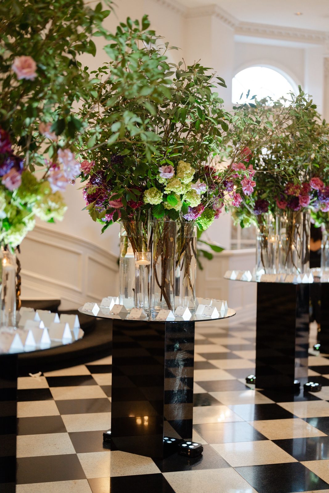 The foyer at The Addison Park dressed with trees on the checkerboard floor
