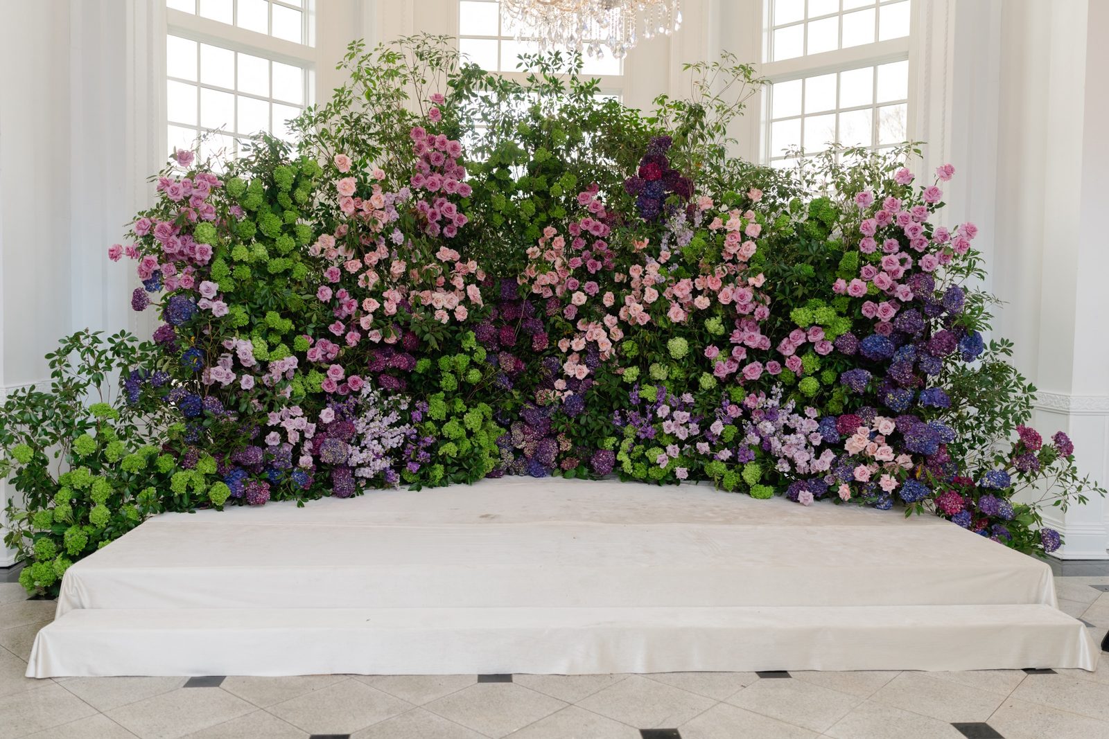 The bride’s seat in front of the flower wall