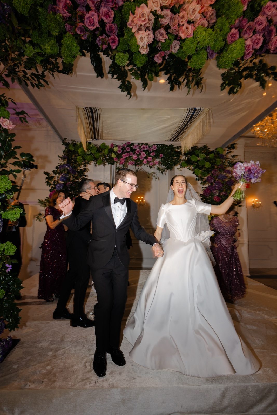 Kayla and Gabriel walking back up the aisle