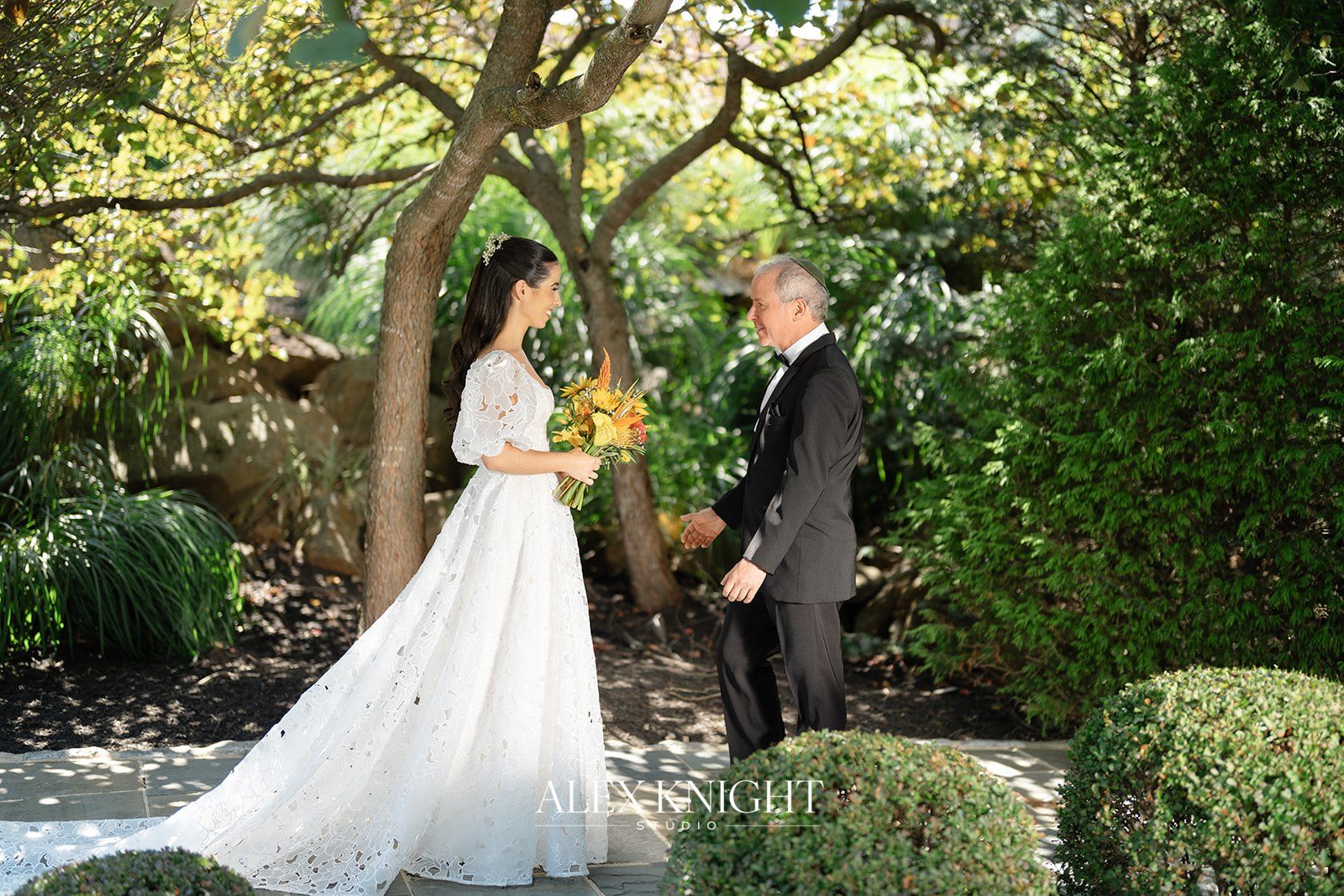 Aline and her father in the gardens before the ceremony