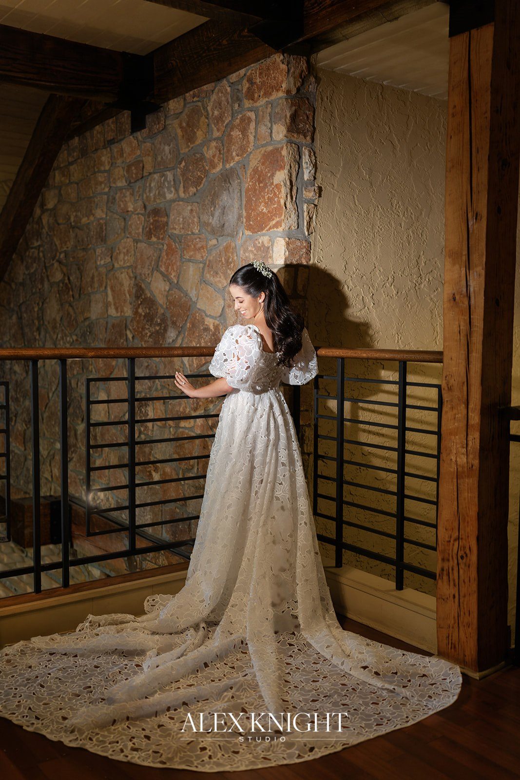 Aline’s full lace train spread across the stone-walled landing at Stone House at Stirling Ridge