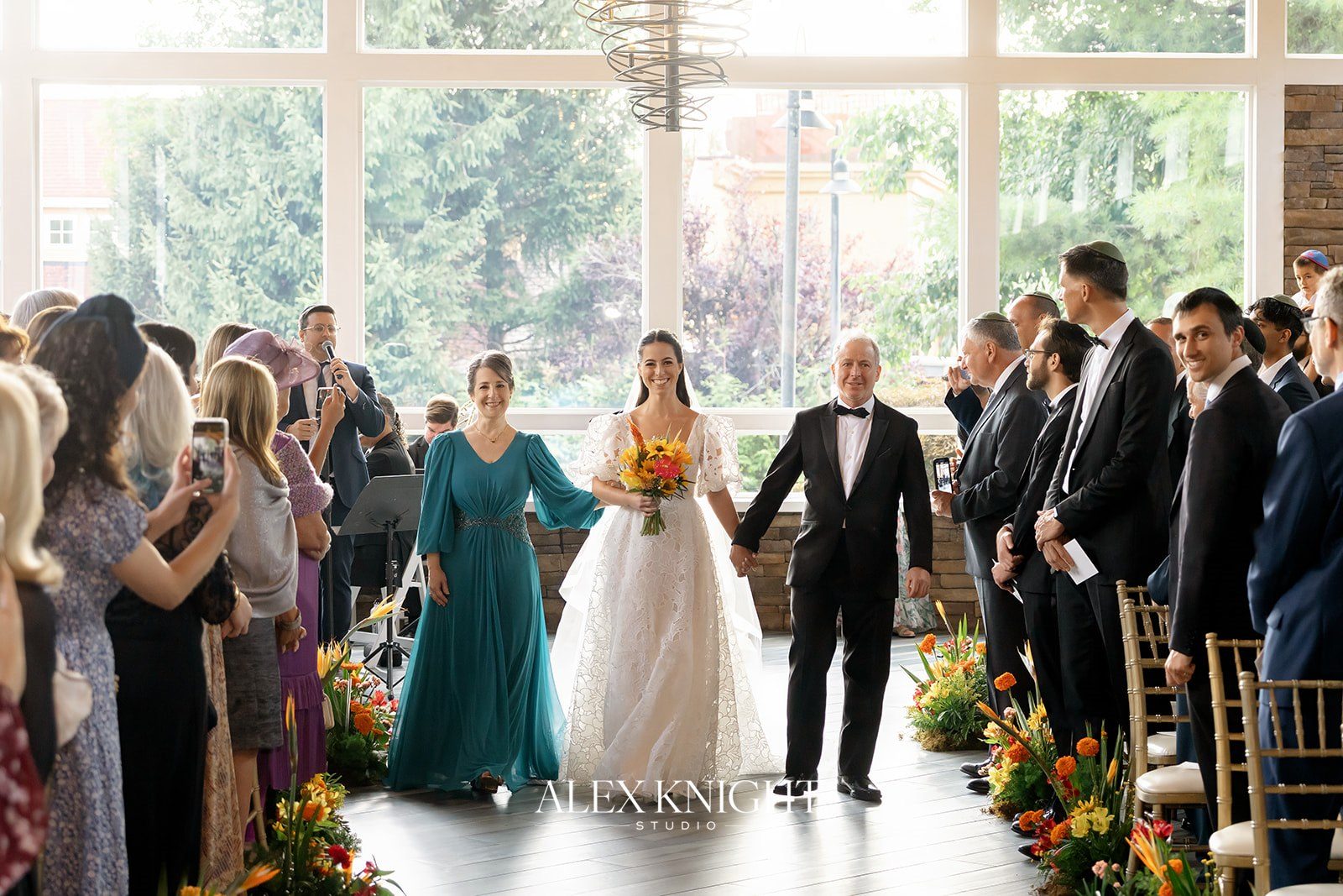 Aline walking down the aisle with her parents