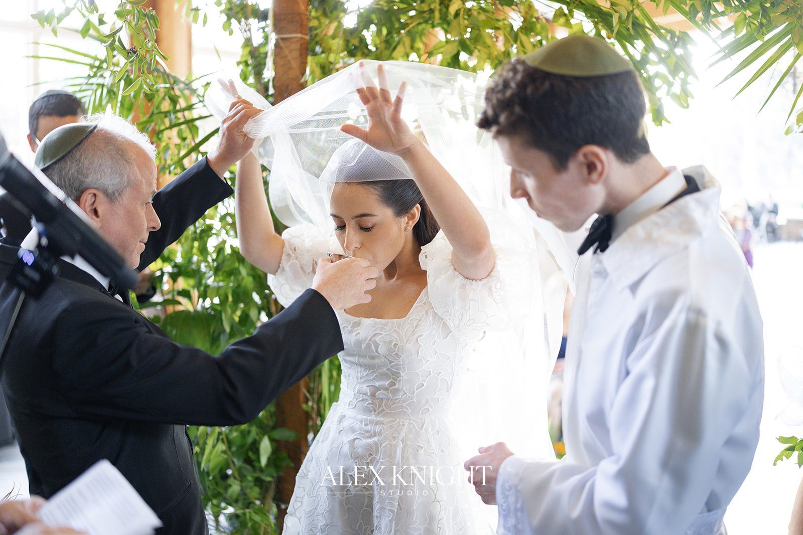 Aline sipping from the kiddush cup under the chuppah