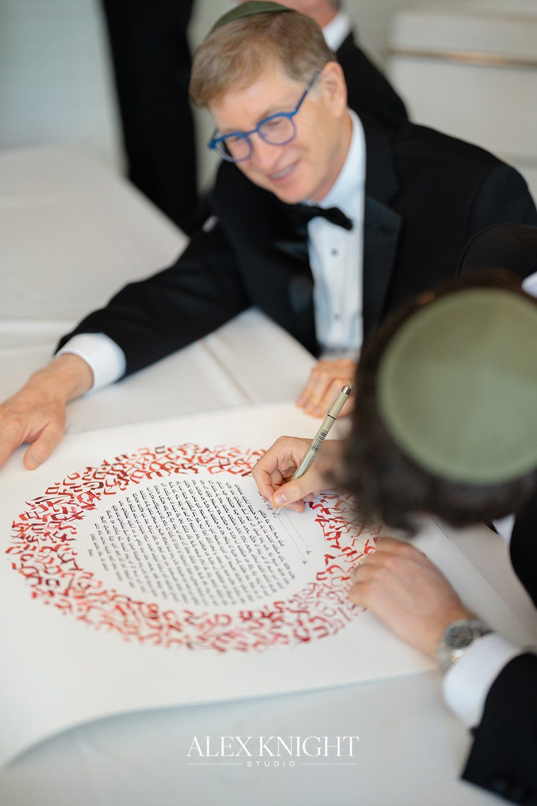 Signing the papercut ketubah before the ceremony