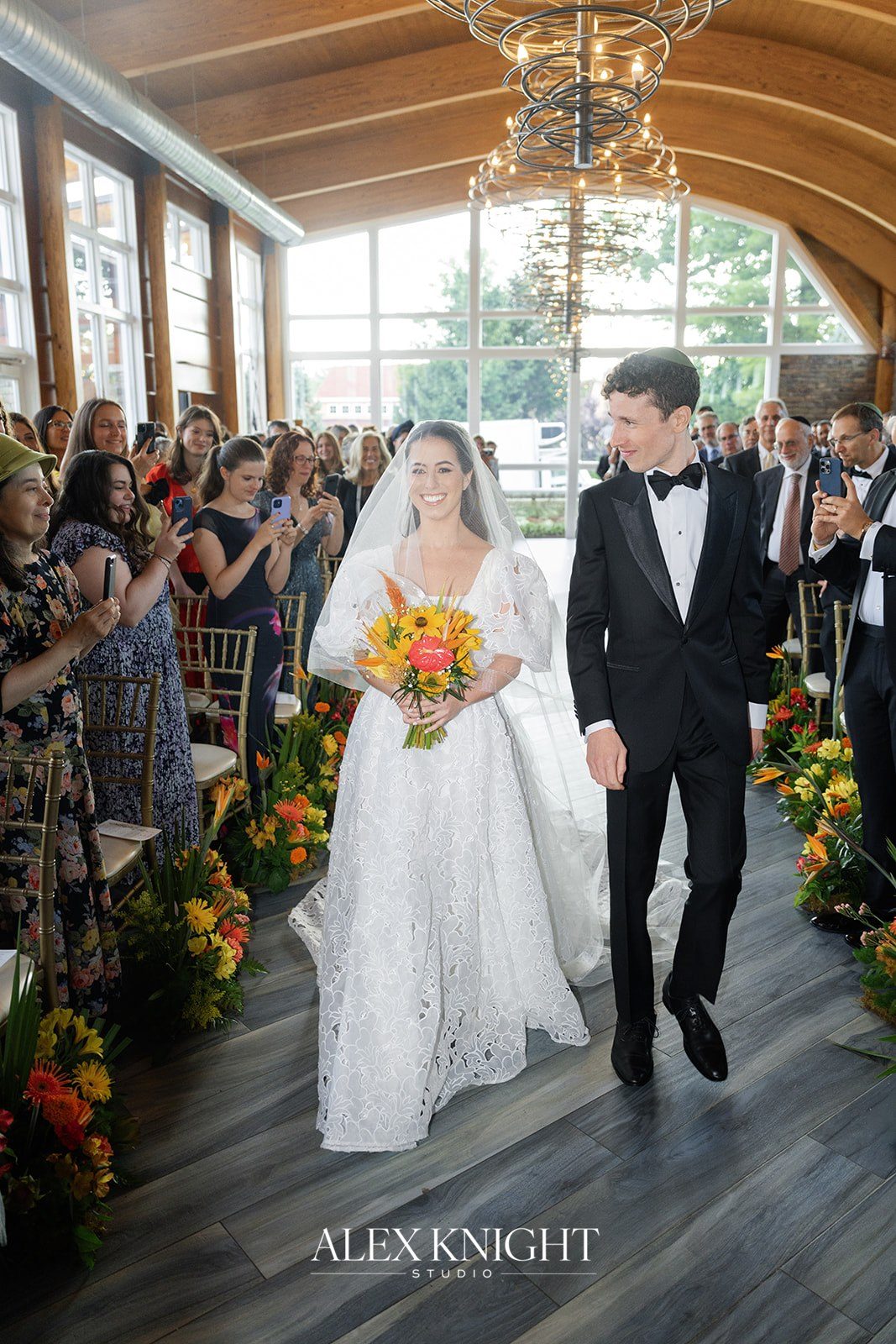 Aline and Tyler walking back up the aisle as husband and wife