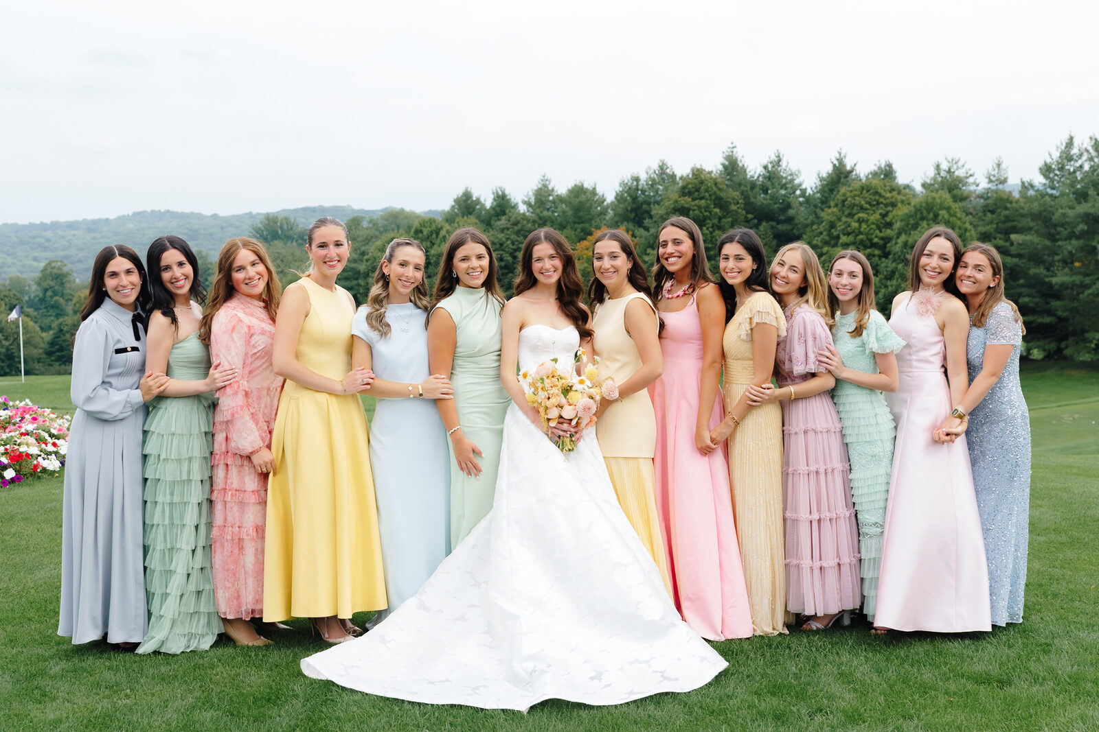 Allie with her bridesmaids in pastel gowns on the golf course