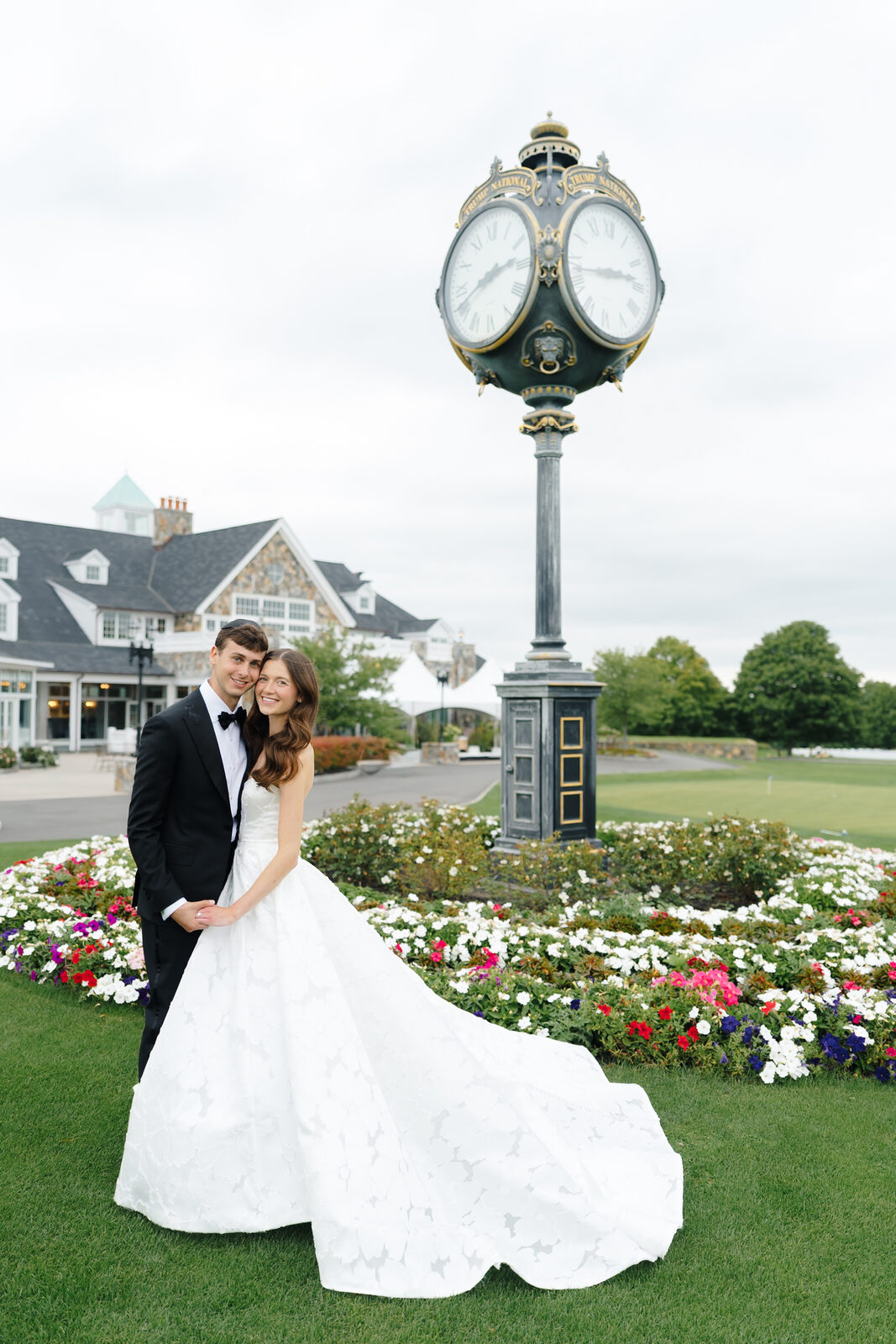 Allie and Charlie beneath the clock in the flower beds at Trump National Westchester