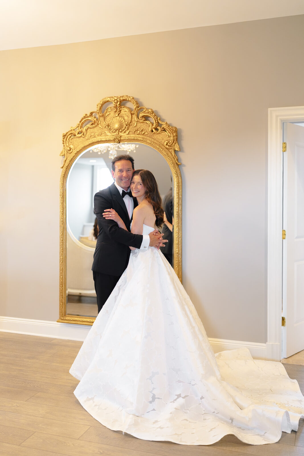 Allie and her father's first look in the gilt mirror of the bridal suite