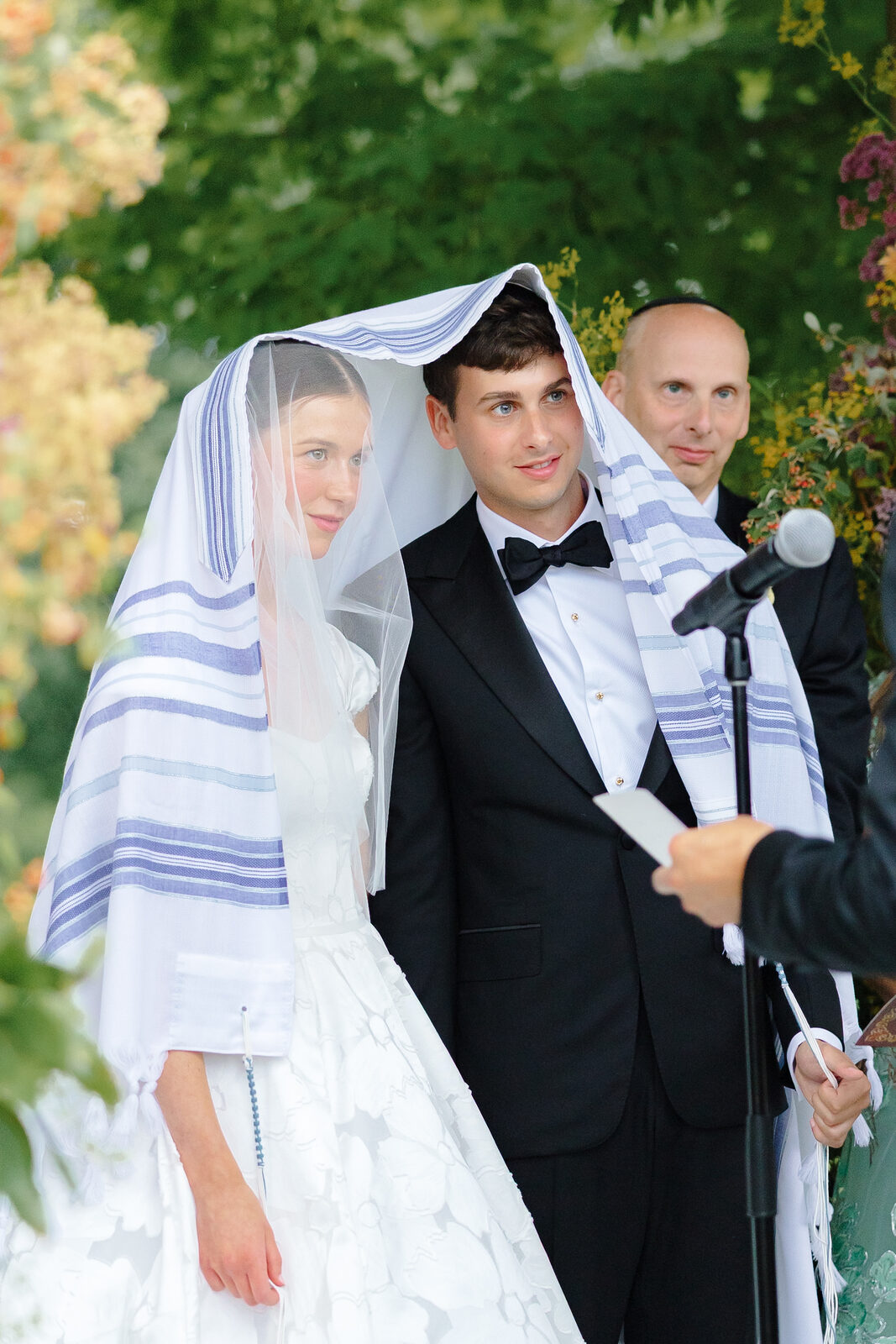 Charlie in a tallit with Allie under the chuppah