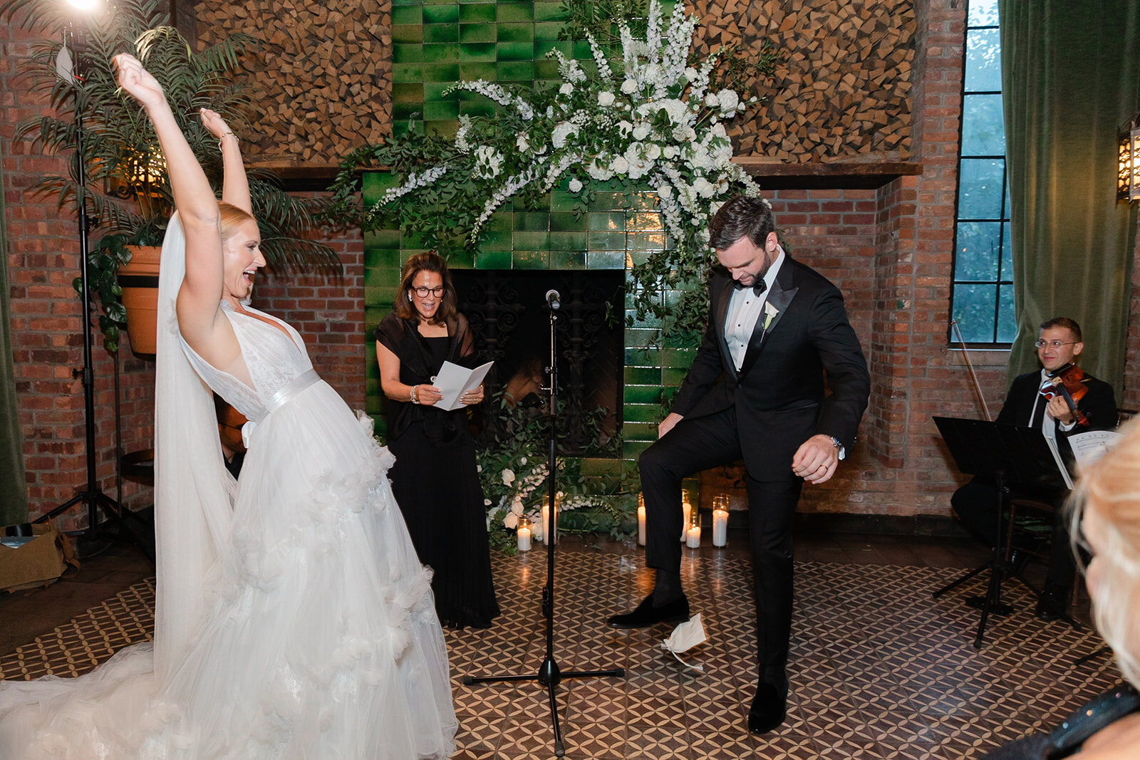 Ashley throws her arms up as the ceremony ends