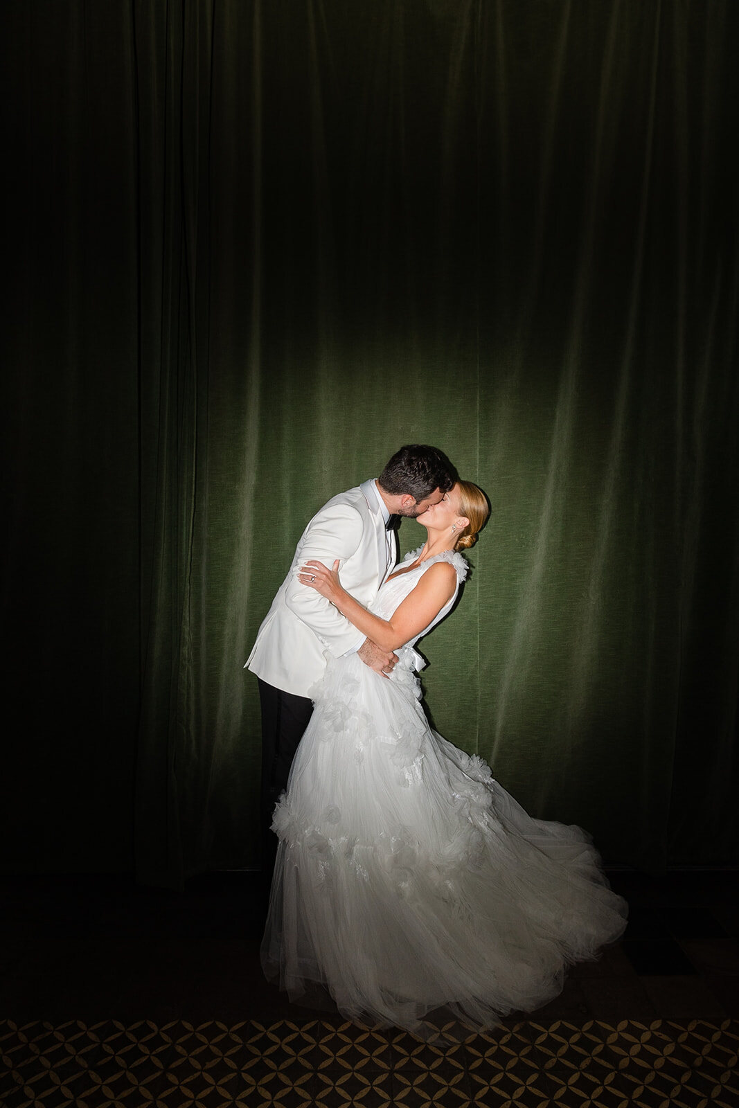 Kendall dips Ashley in front of the green curtain