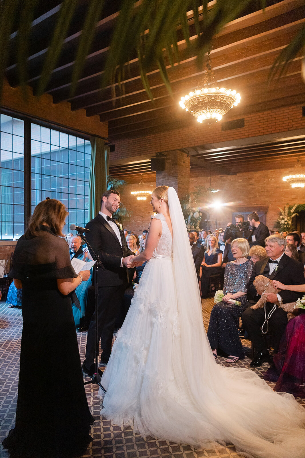 Ashley’s veil trails behind her as she reaches the fireplace altar
