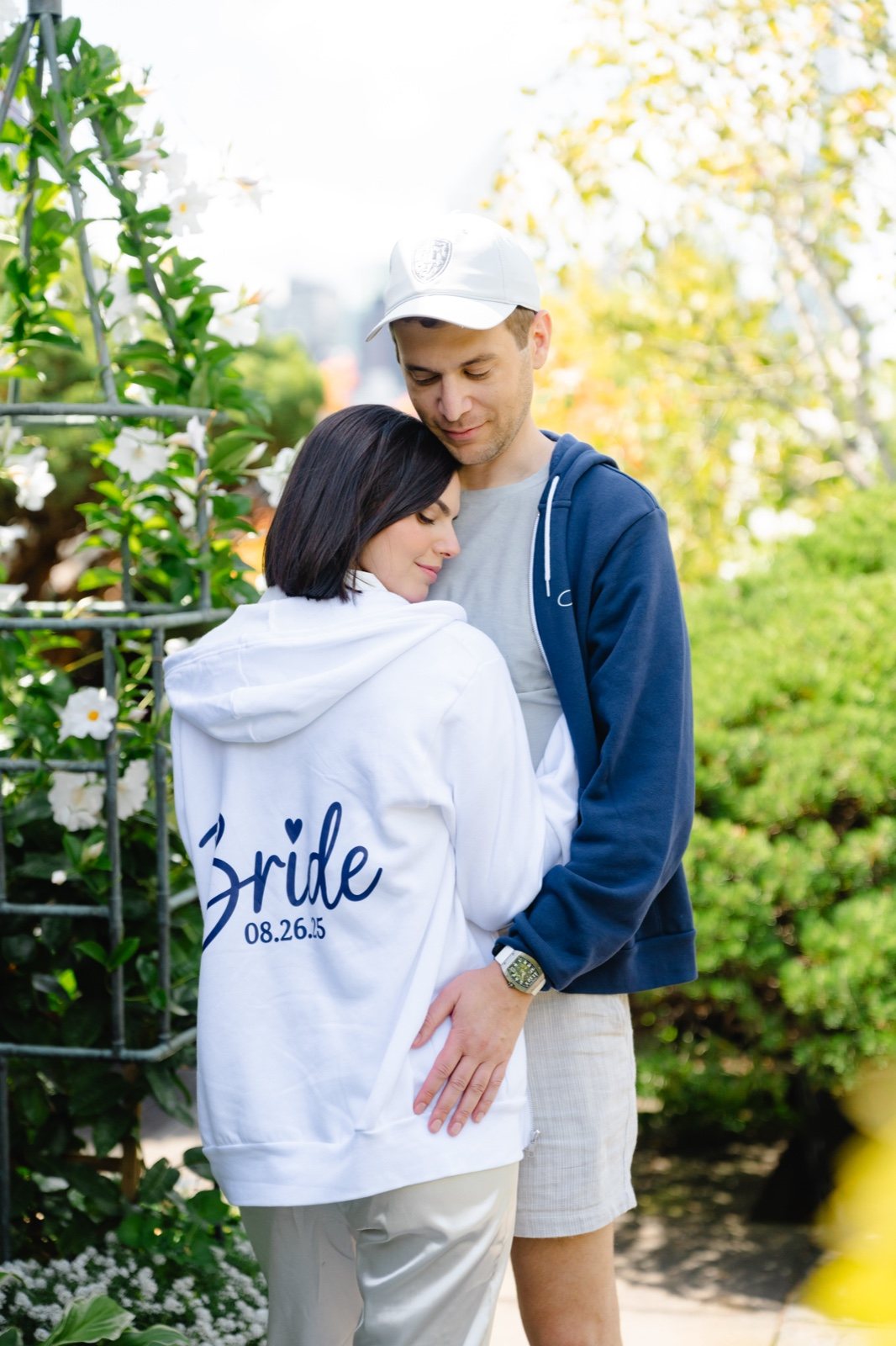 Daniella and Adam in matching Bride and Groom hoodies