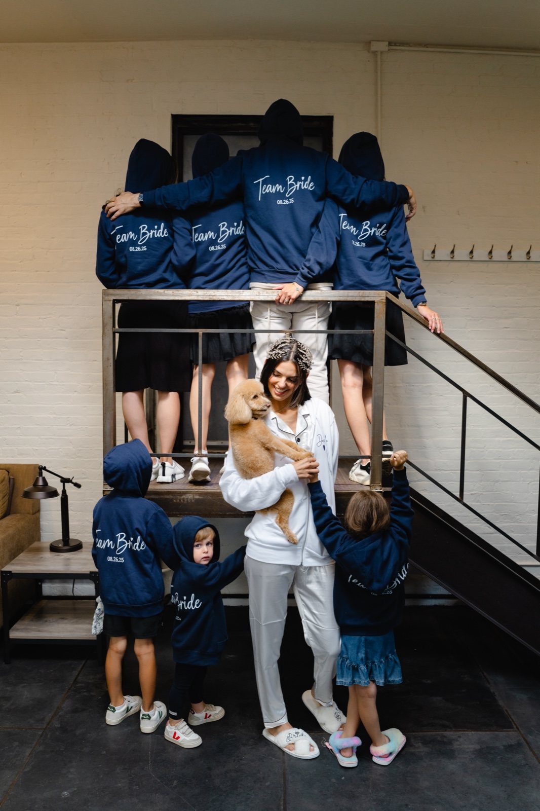 The family in matching navy hoodies on the stairs