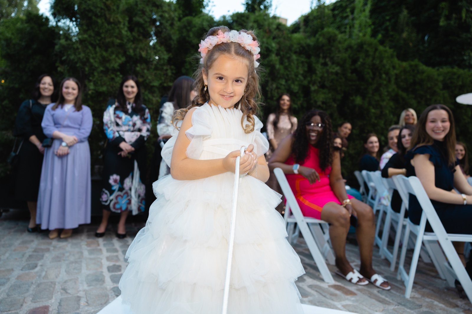 The flower girl walks the aisle