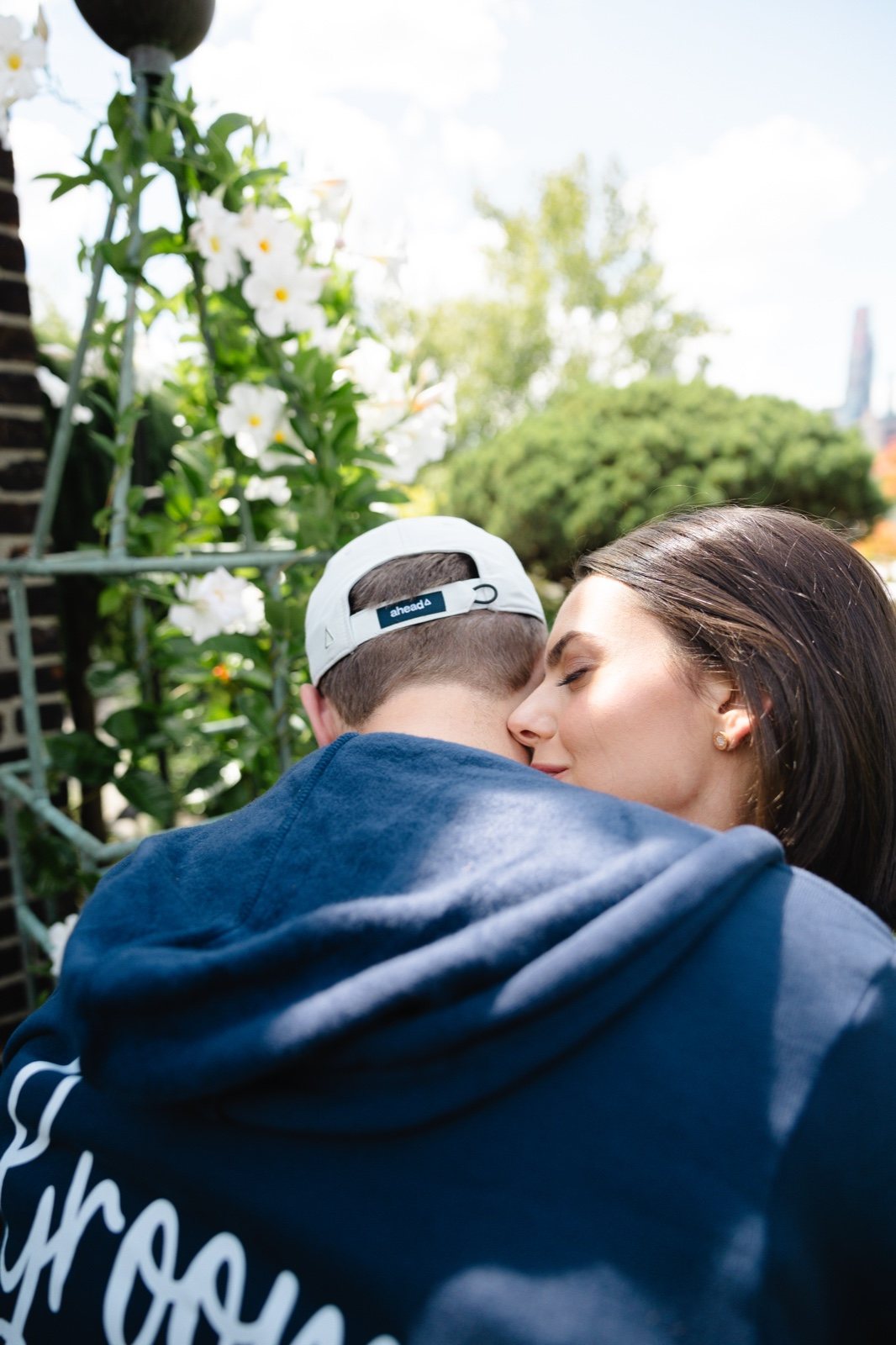 Adam and Daniella hugging in their hoodies