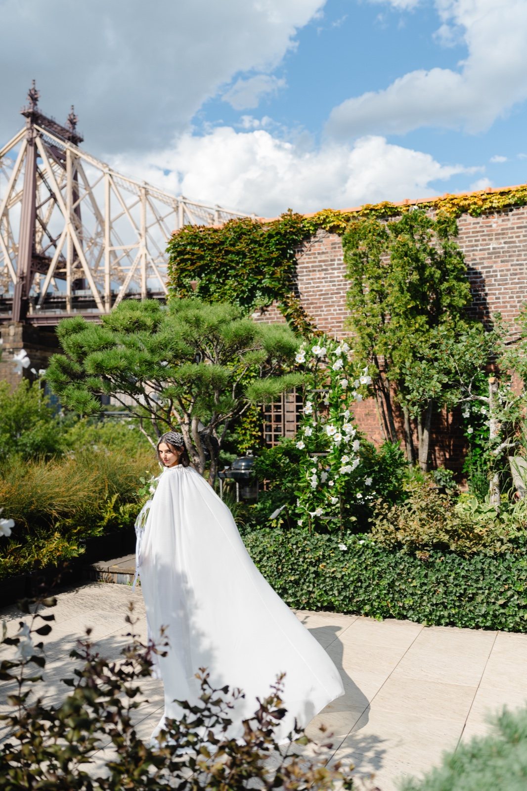Daniella in the garden with the Queensboro Bridge behind her
