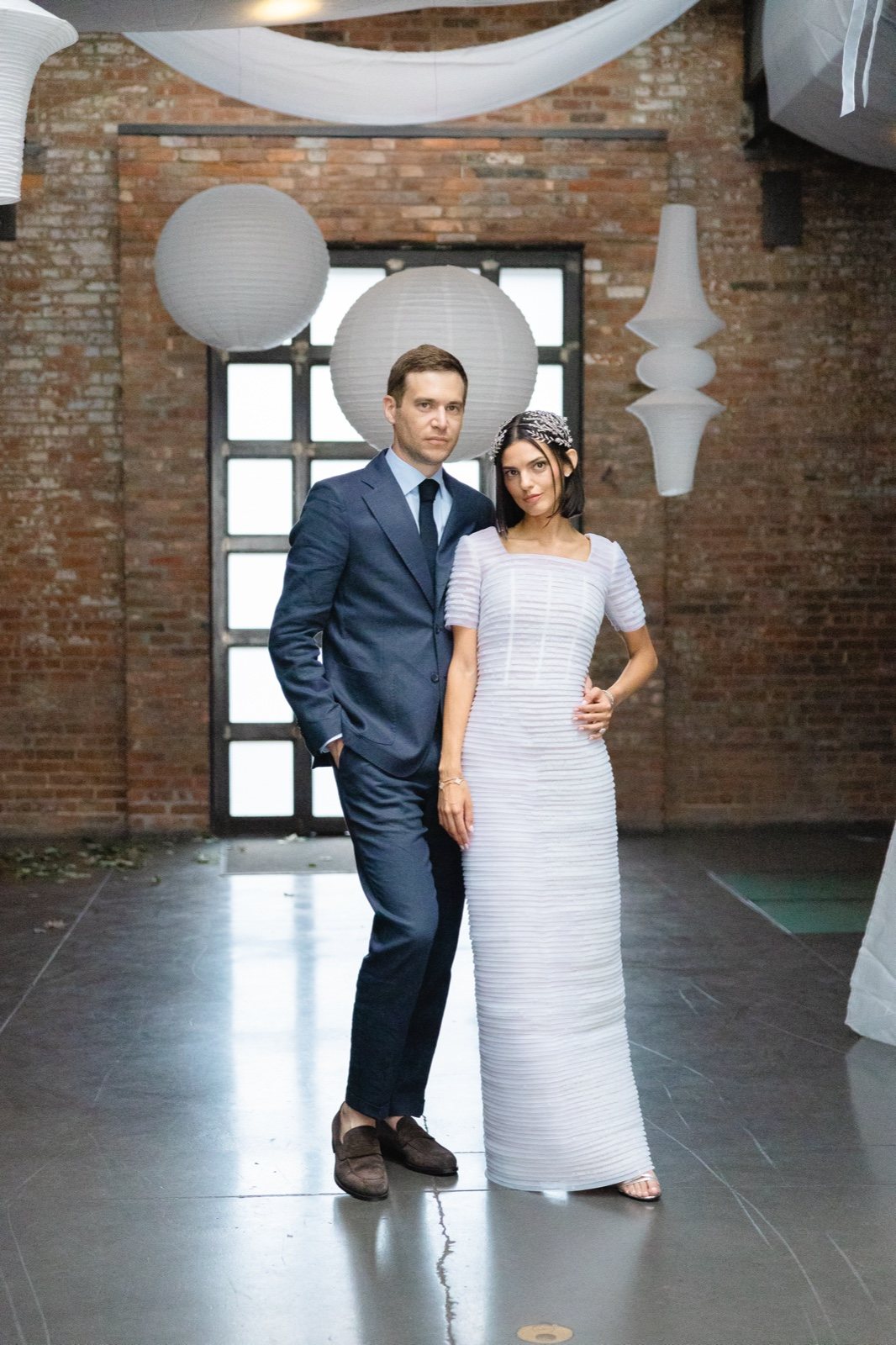 In the brick hall hung with white drapes