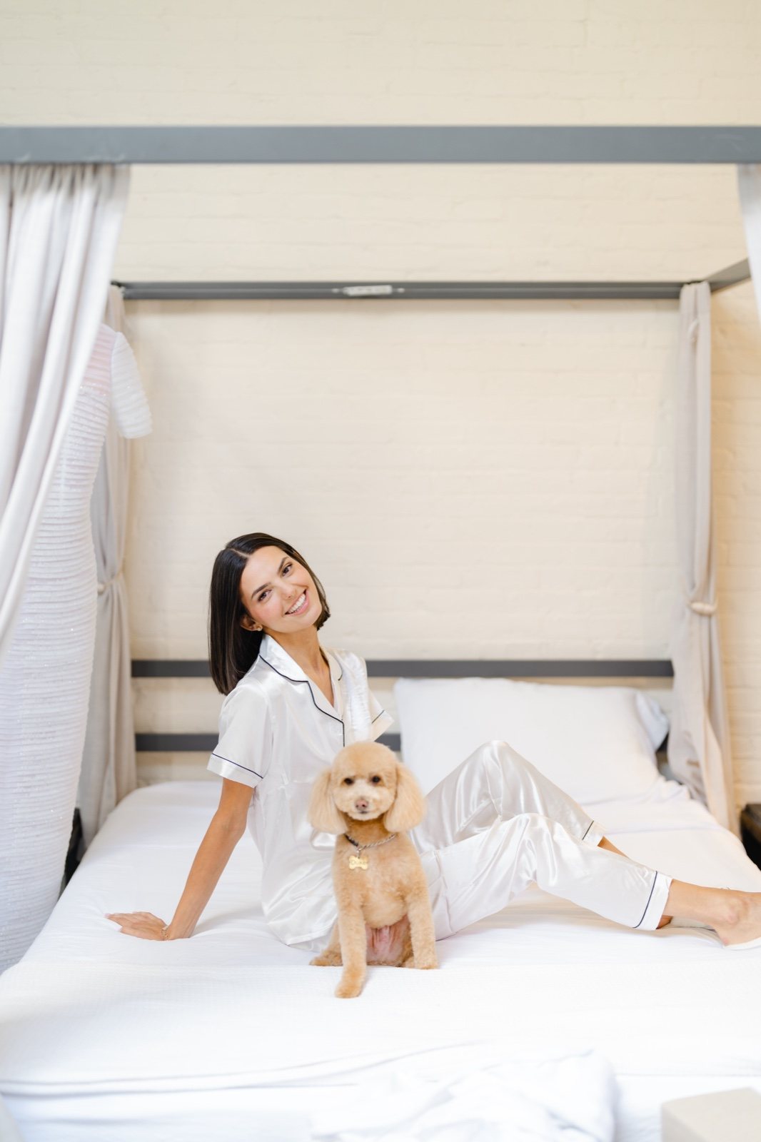 Daniella on the bed beside her gown