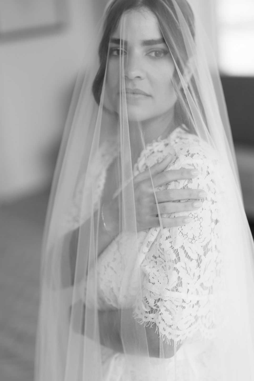 Dharma beneath her cathedral veil, photographed in soft black and white