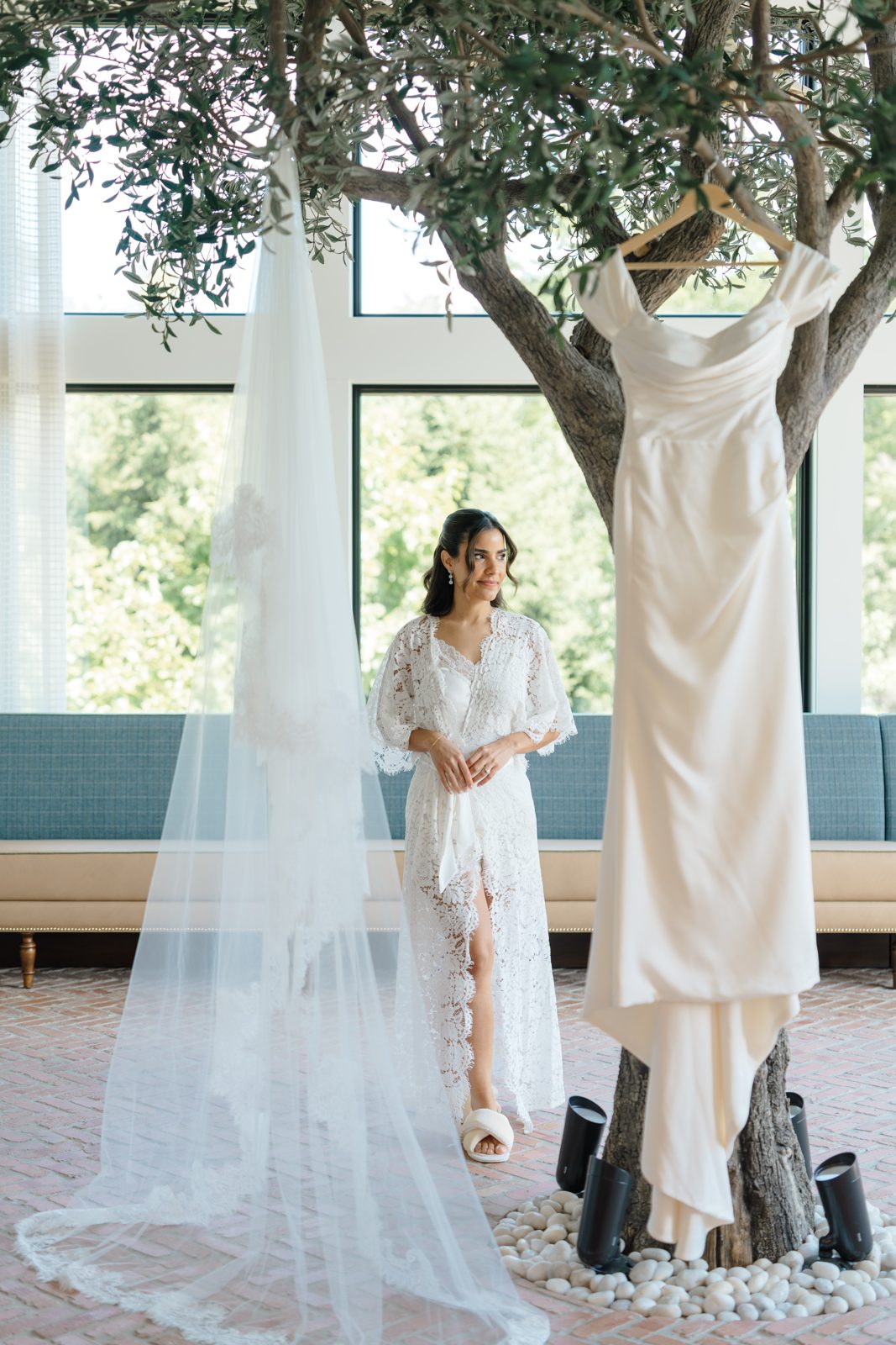 Dharma in the bridal suite at Bear Brook Valley, her gown hanging in the window light